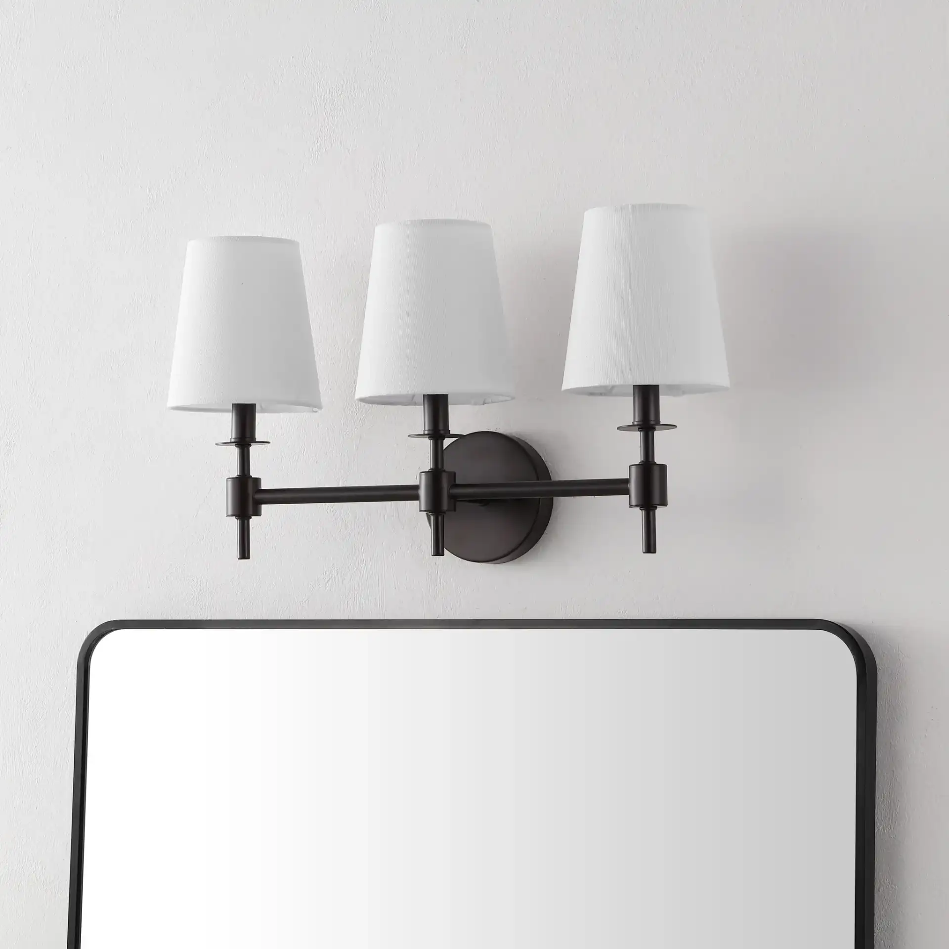 Davielle Three-Light Wall Sconce in Black in a styled room