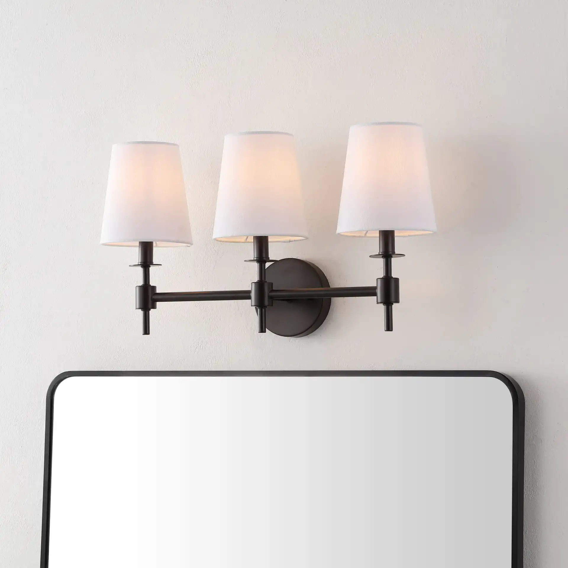 Davielle Three-Light Wall Sconce in Black in a styled room
