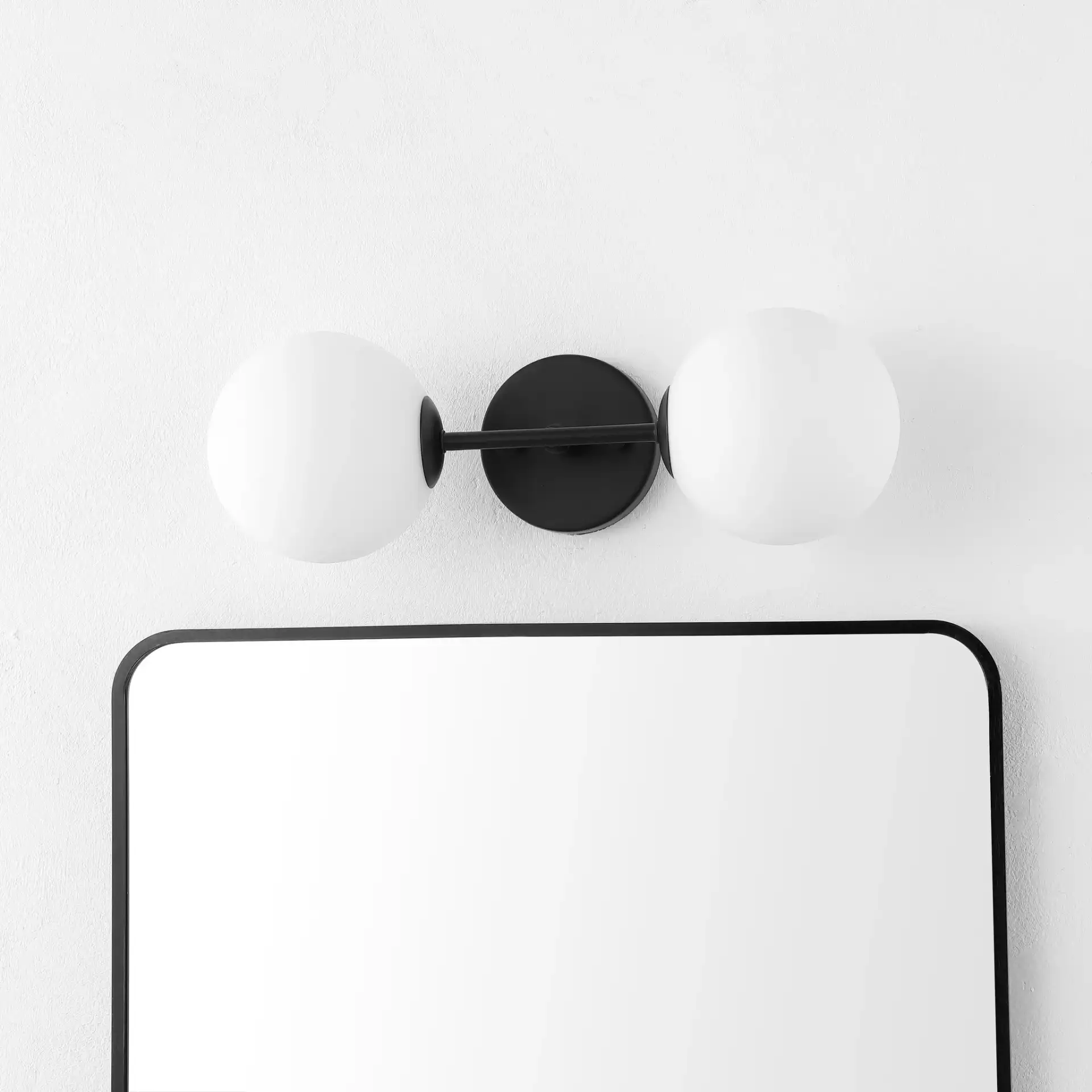 Hymn Two-Light Wall Sconce in Black in a styled room