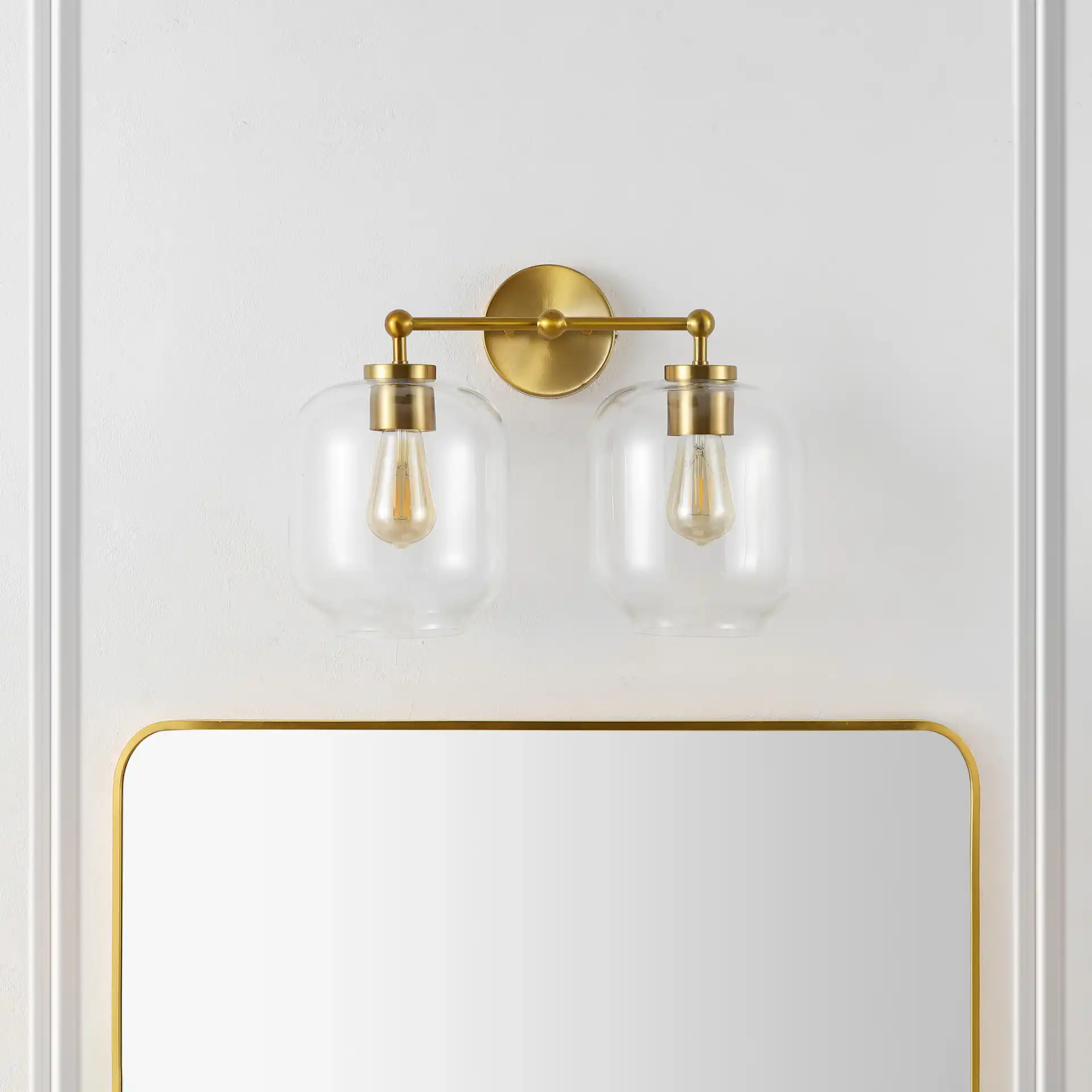 Navia Two-Light Wall Sconce in Brass in a styled room