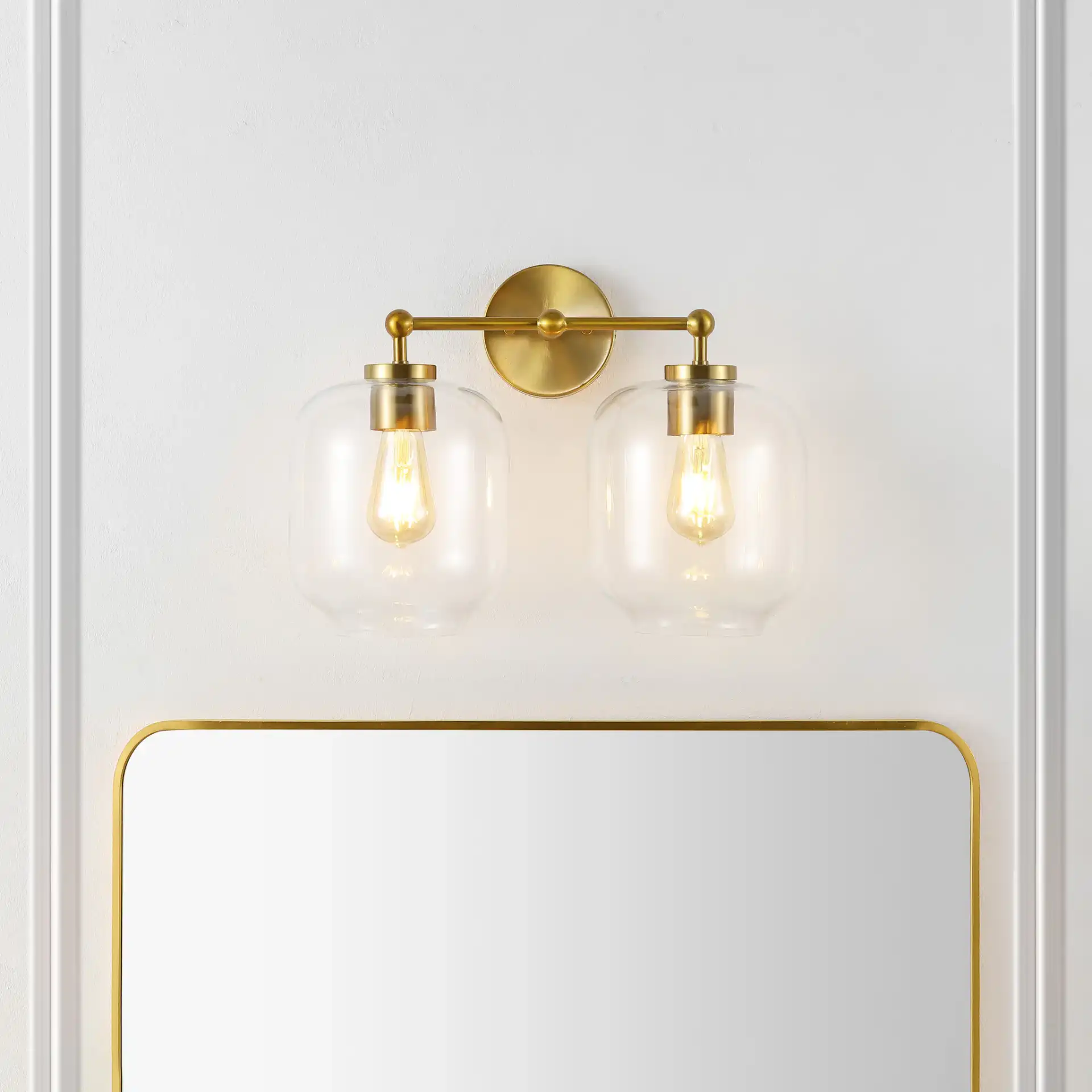 Navia Two-Light Wall Sconce in Brass in a styled room