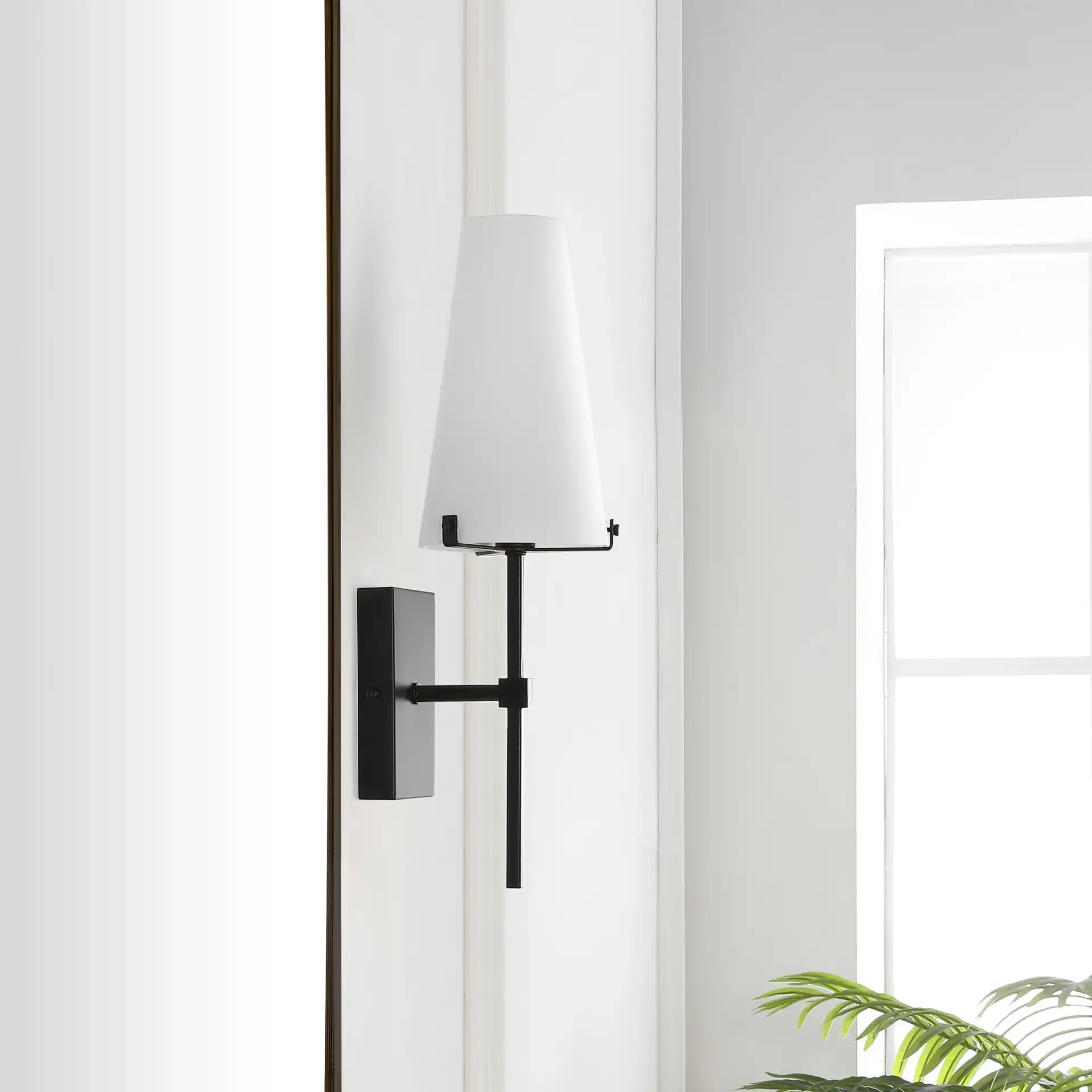 Nanda Wall Sconce in Black in a styled room