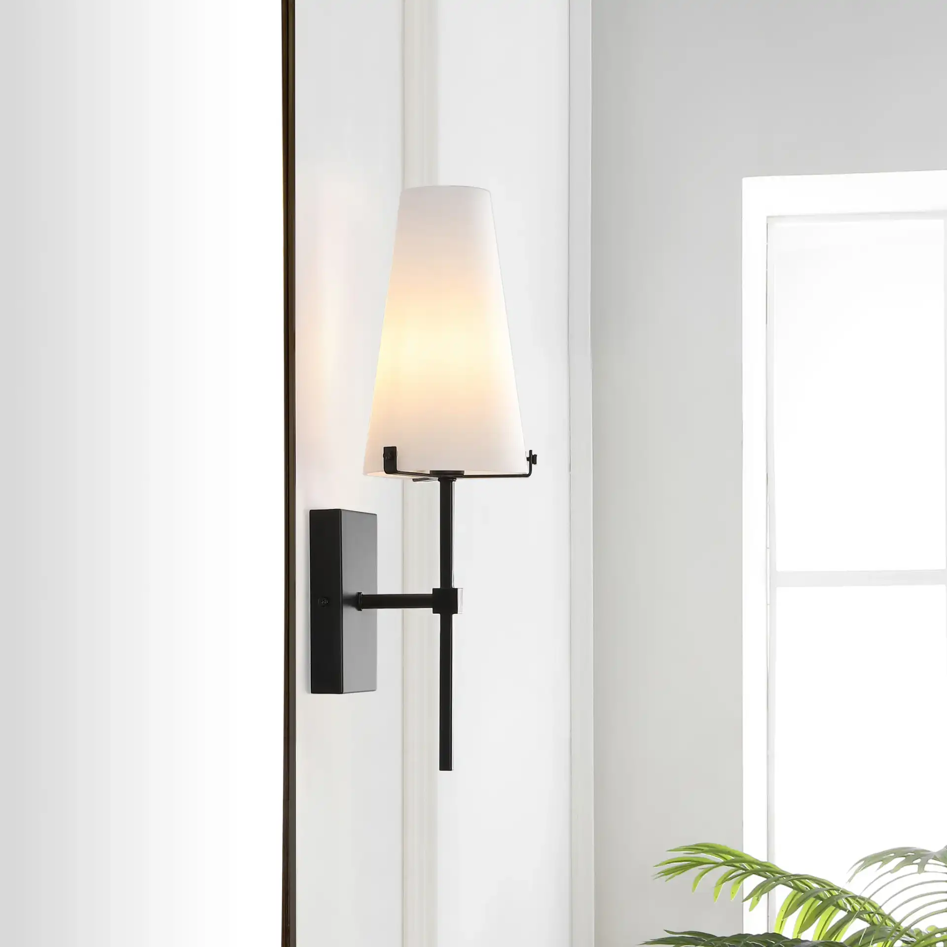 Nanda Wall Sconce in Black in a styled room