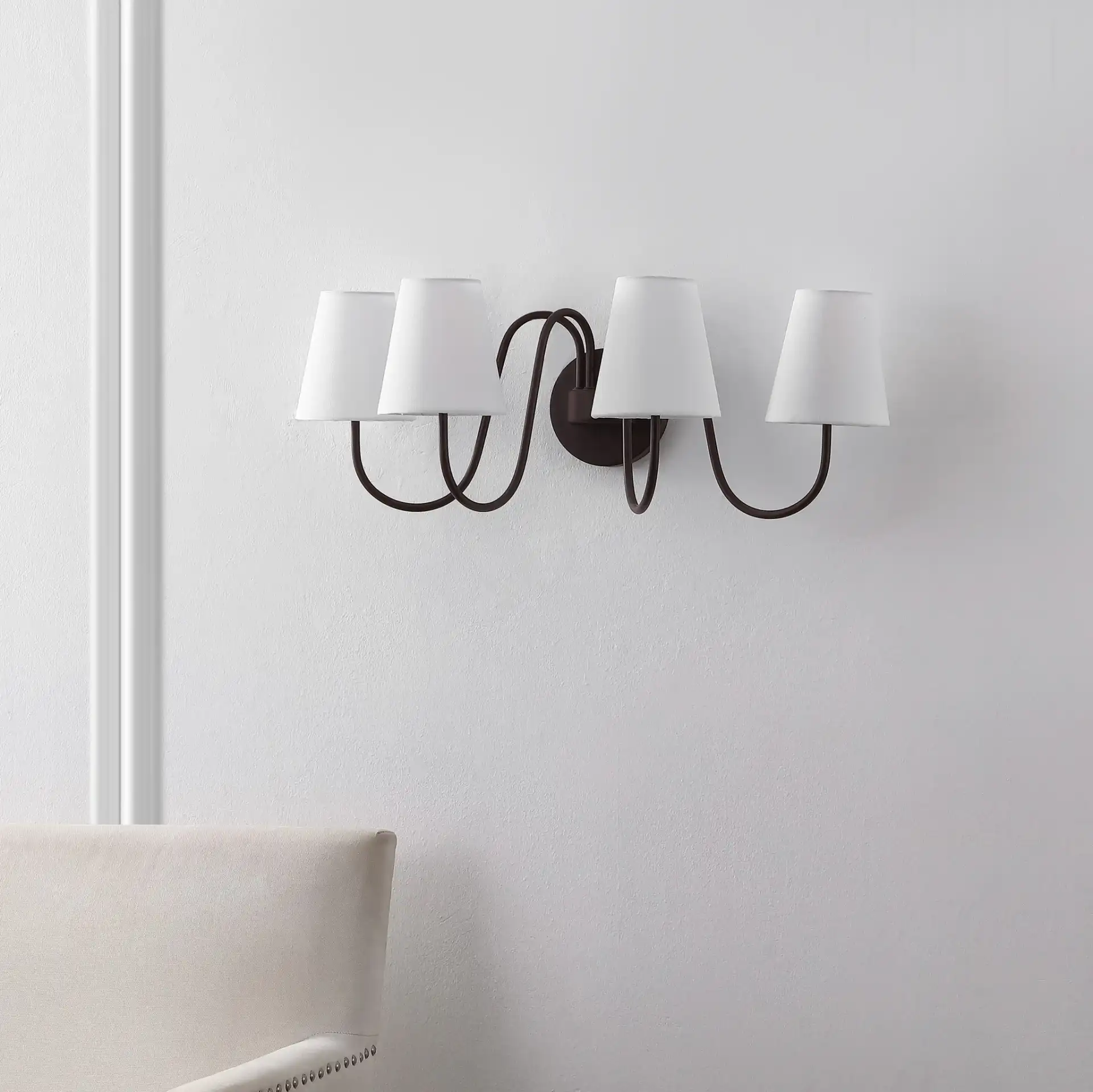 Rhea Four-Light Wall Sconce in Oil Rub Bronze in a styled room