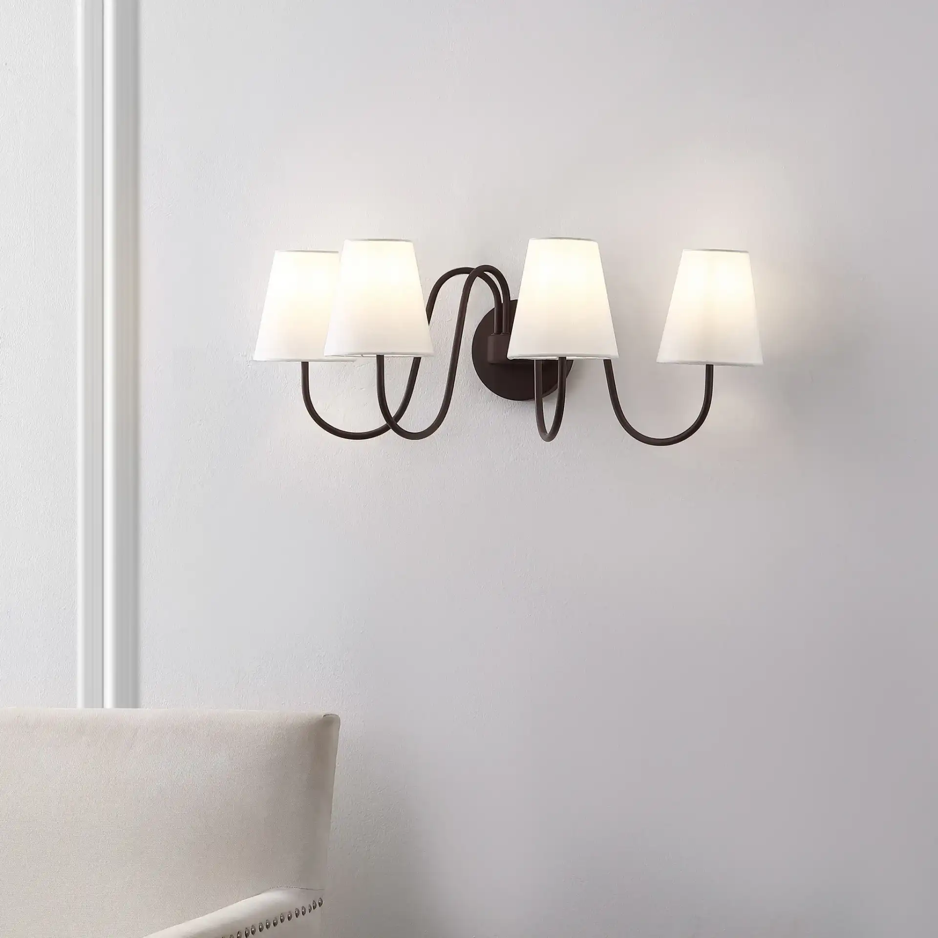 Rhea Four-Light Wall Sconce in Oil Rub Bronze in a styled room