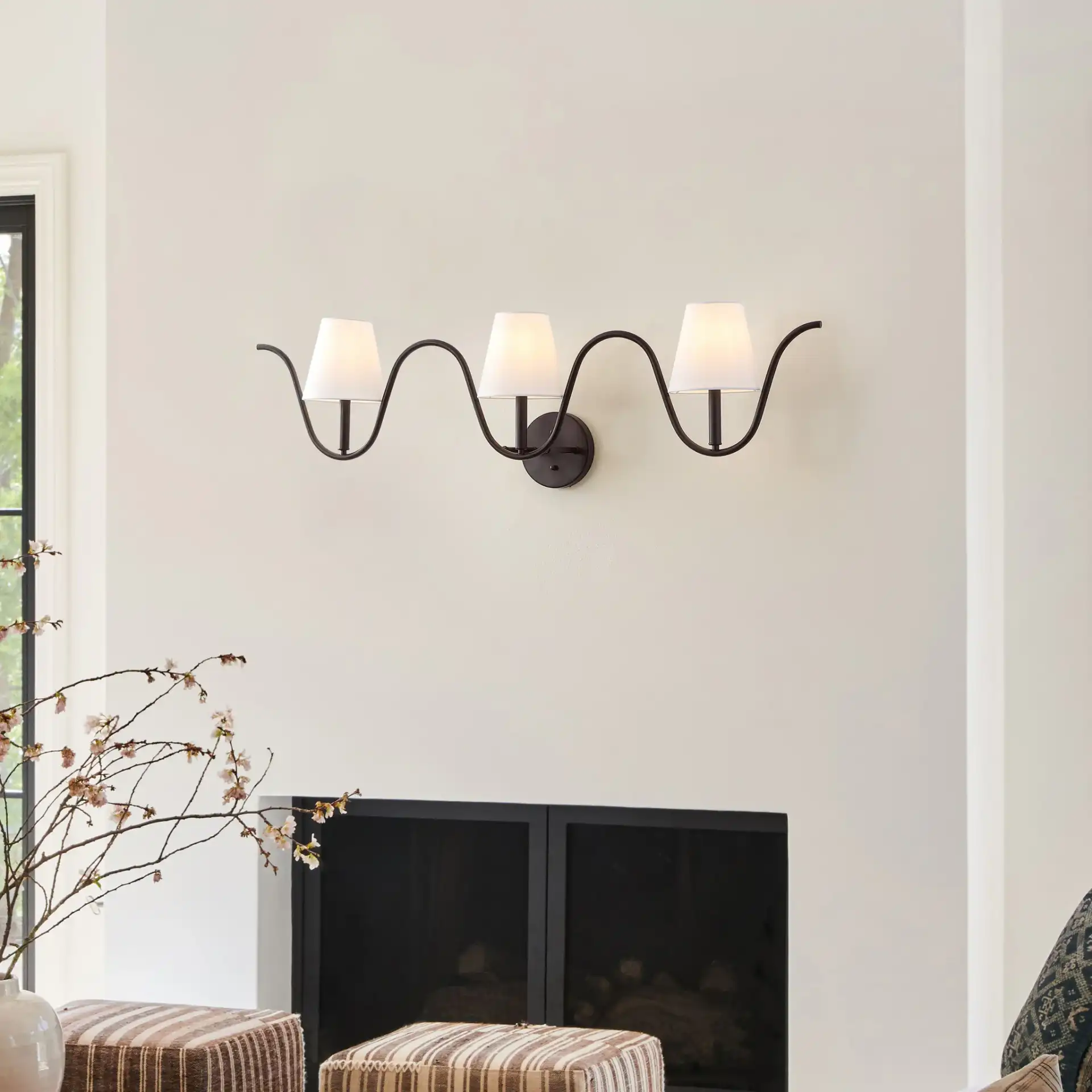 Rylie Three-Light Wall Sconce in Oil Rub Bronze in a styled room