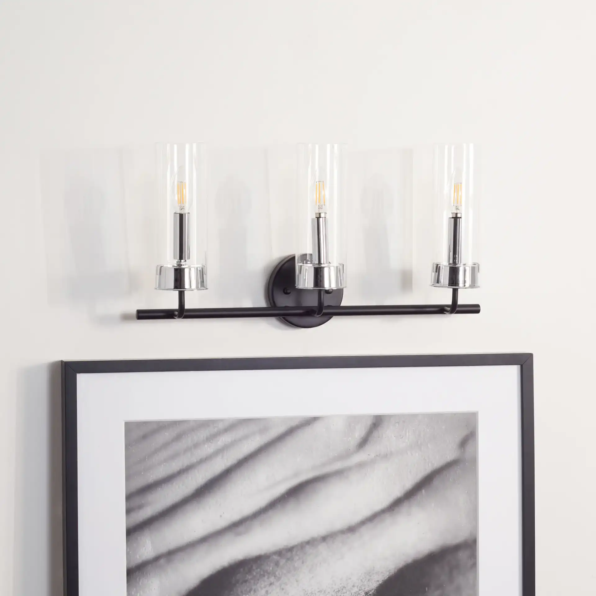 Remery Vanity Sconce in Chrome / Black in a styled room