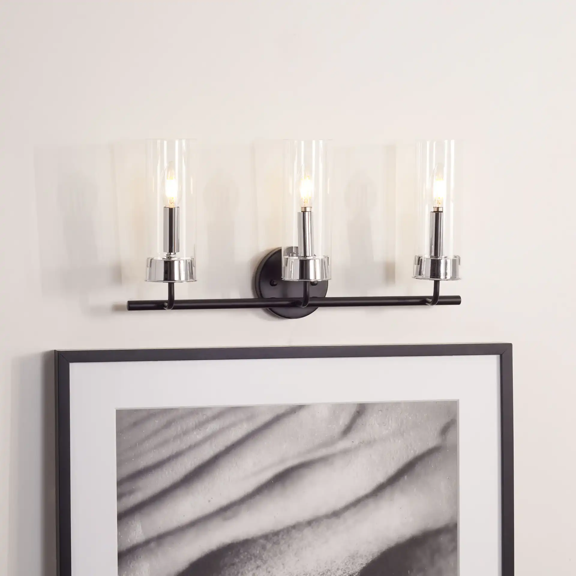 Remery Vanity Sconce in Chrome / Black in a styled room