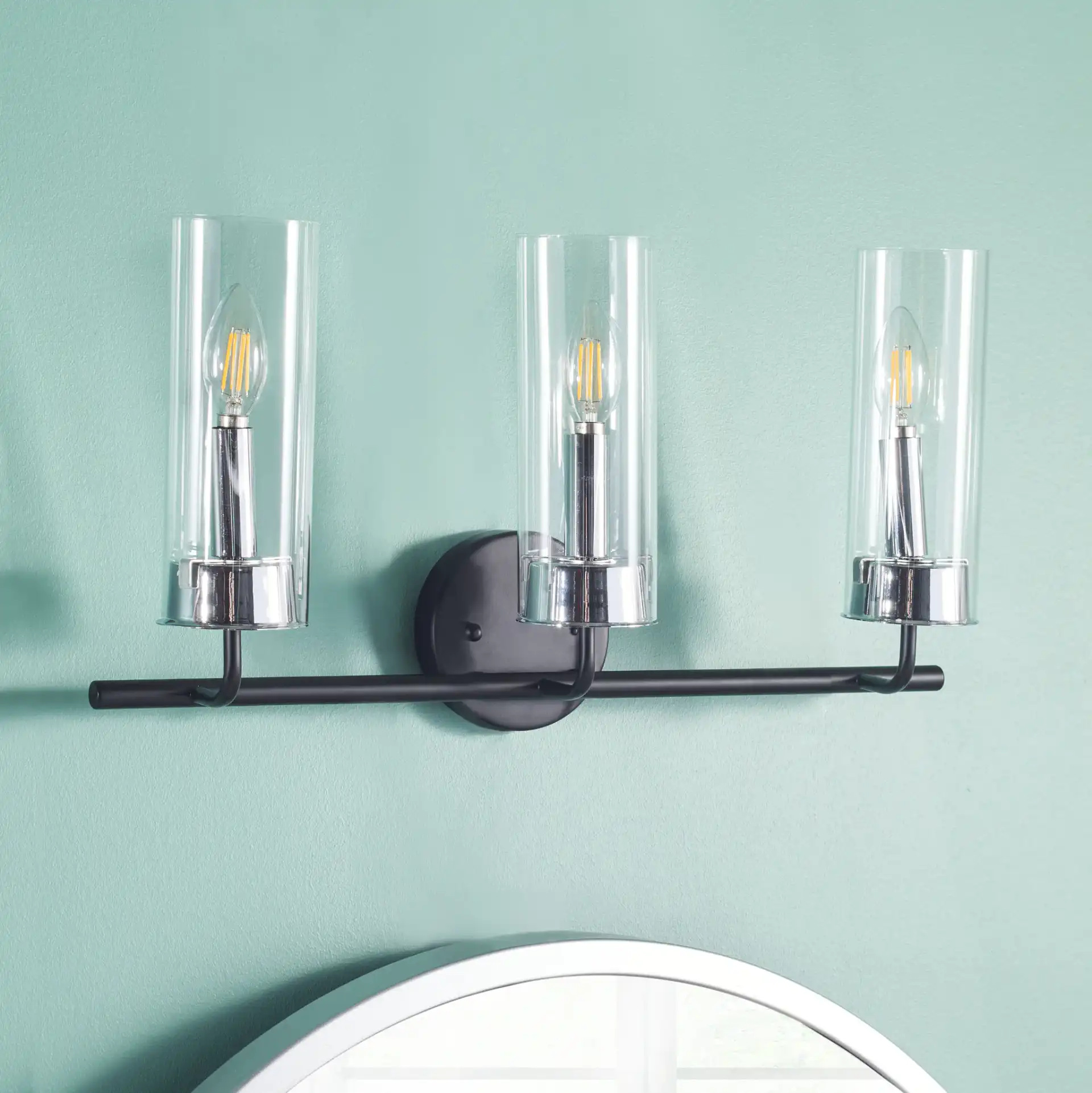 Remery Vanity Sconce in Chrome / Black in a styled room