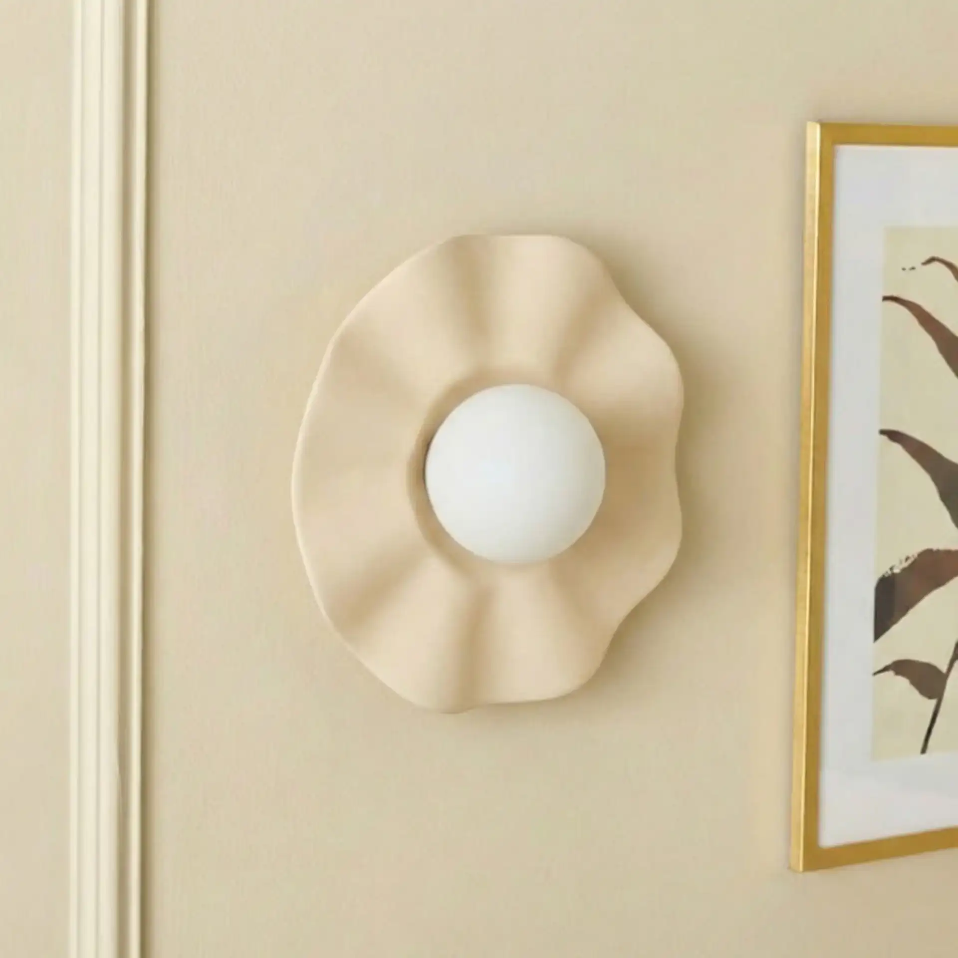 Renza Wall Sconce in Ivory in a styled room