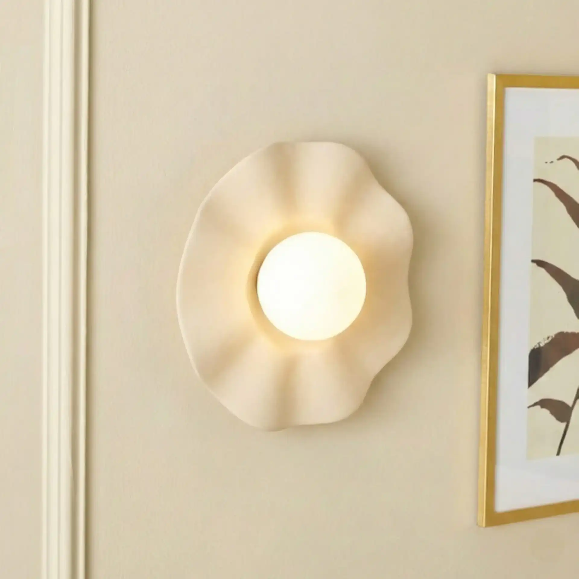 Renza Wall Sconce in Ivory in a styled room