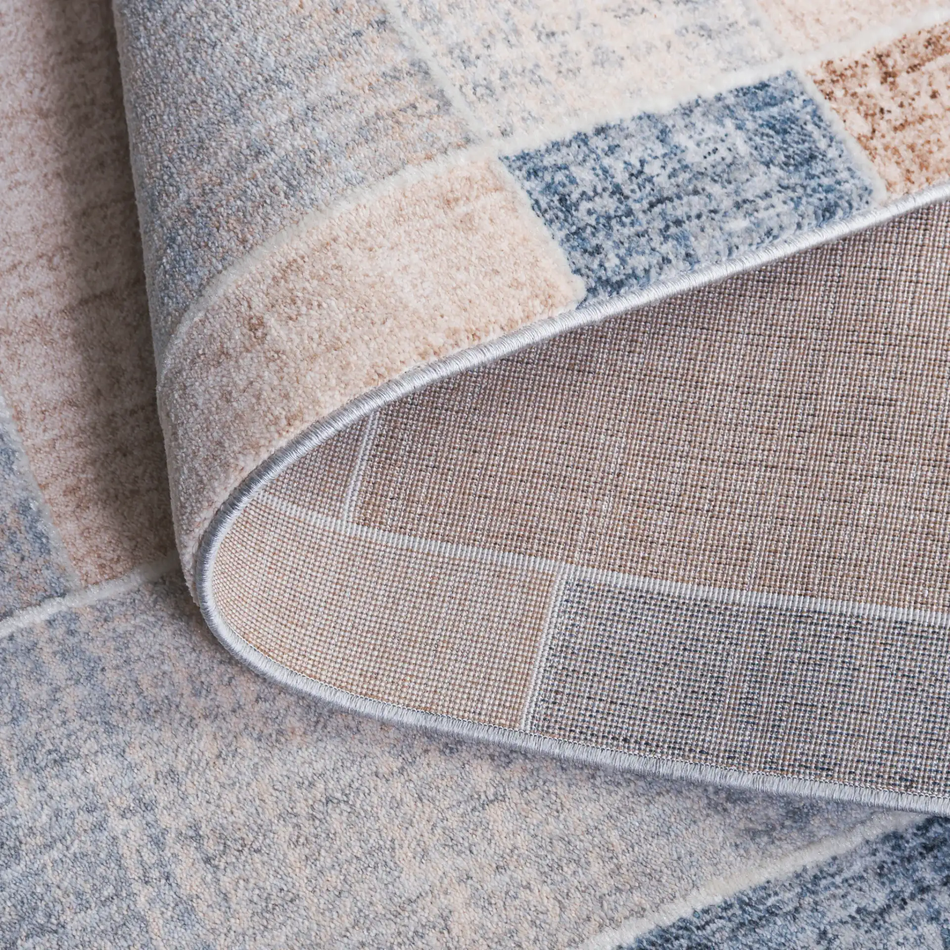 Scarlett Block Patchwork Rug in Beige / Blue Brown in a styled room