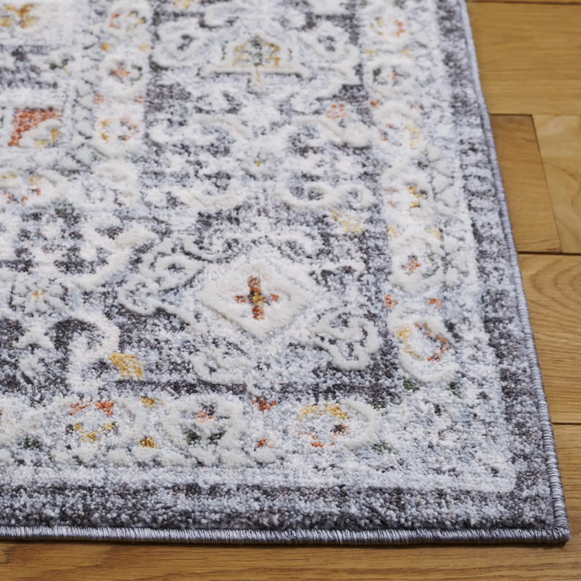 Scarlett Distressed Medallion Rug in Dark Gray / Ivory Rust in a styled room