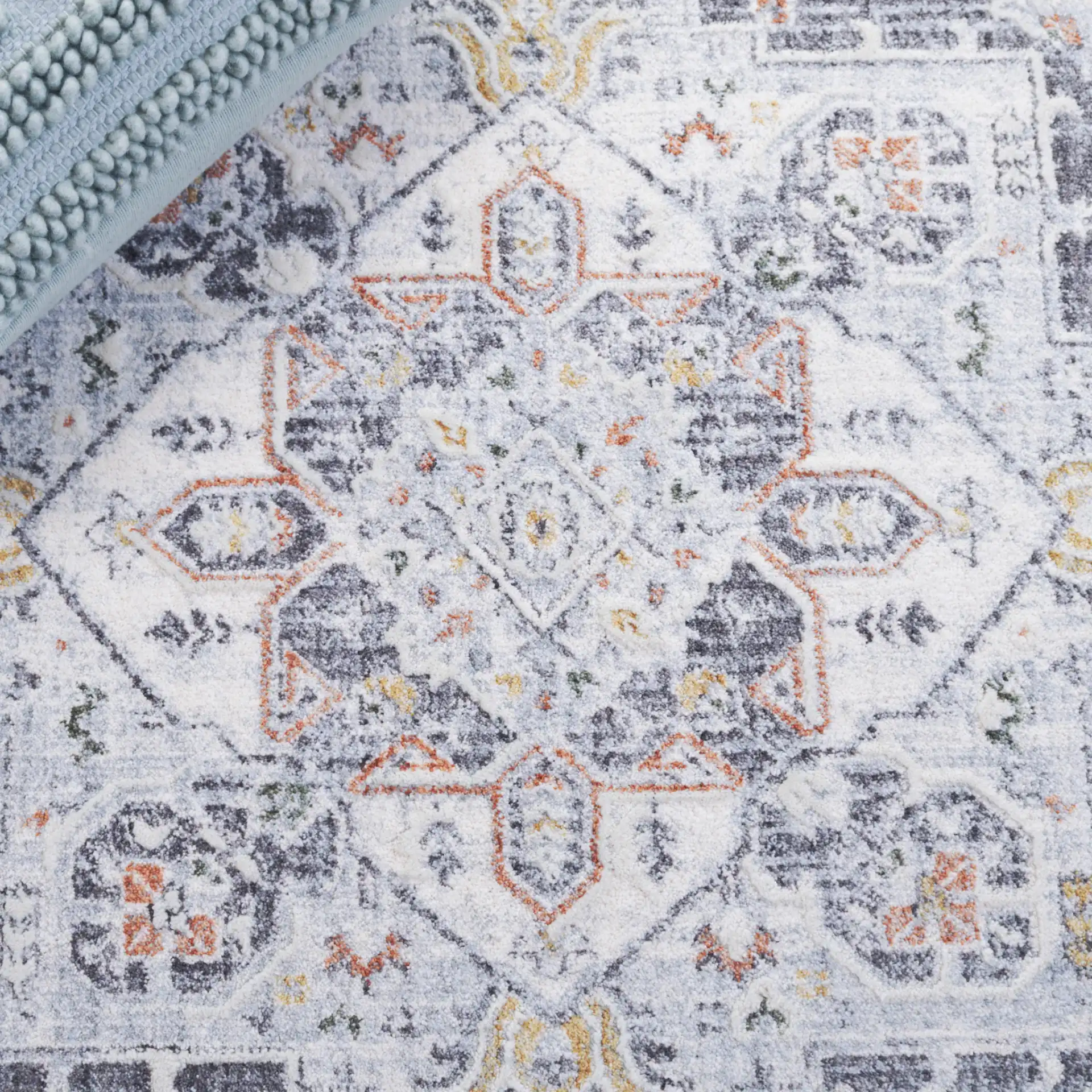 Scarlett Distressed Medallion Rug in Dark Gray / Ivory Rust in a styled room
