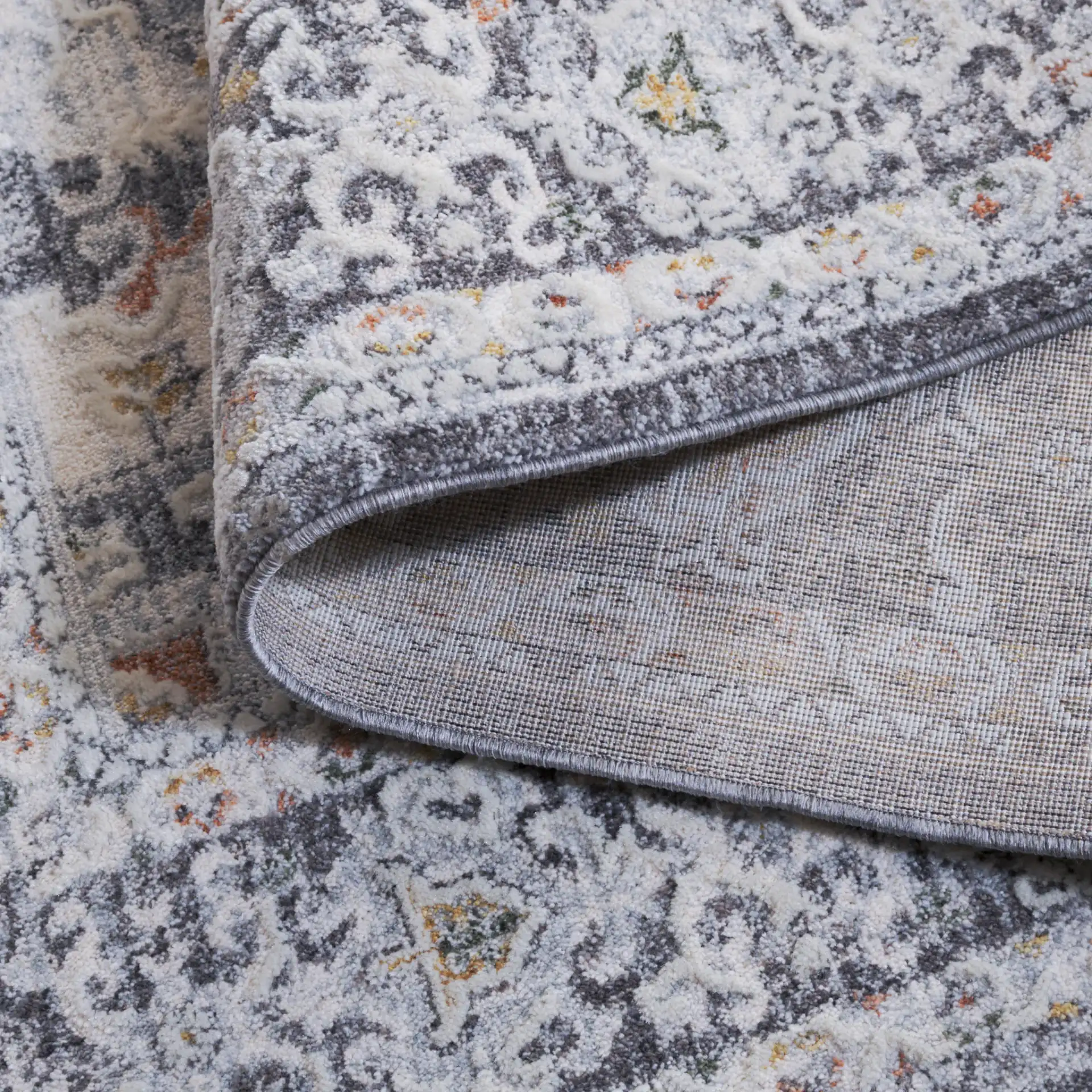 Scarlett Distressed Medallion Rug in Dark Gray / Ivory Rust in a styled room