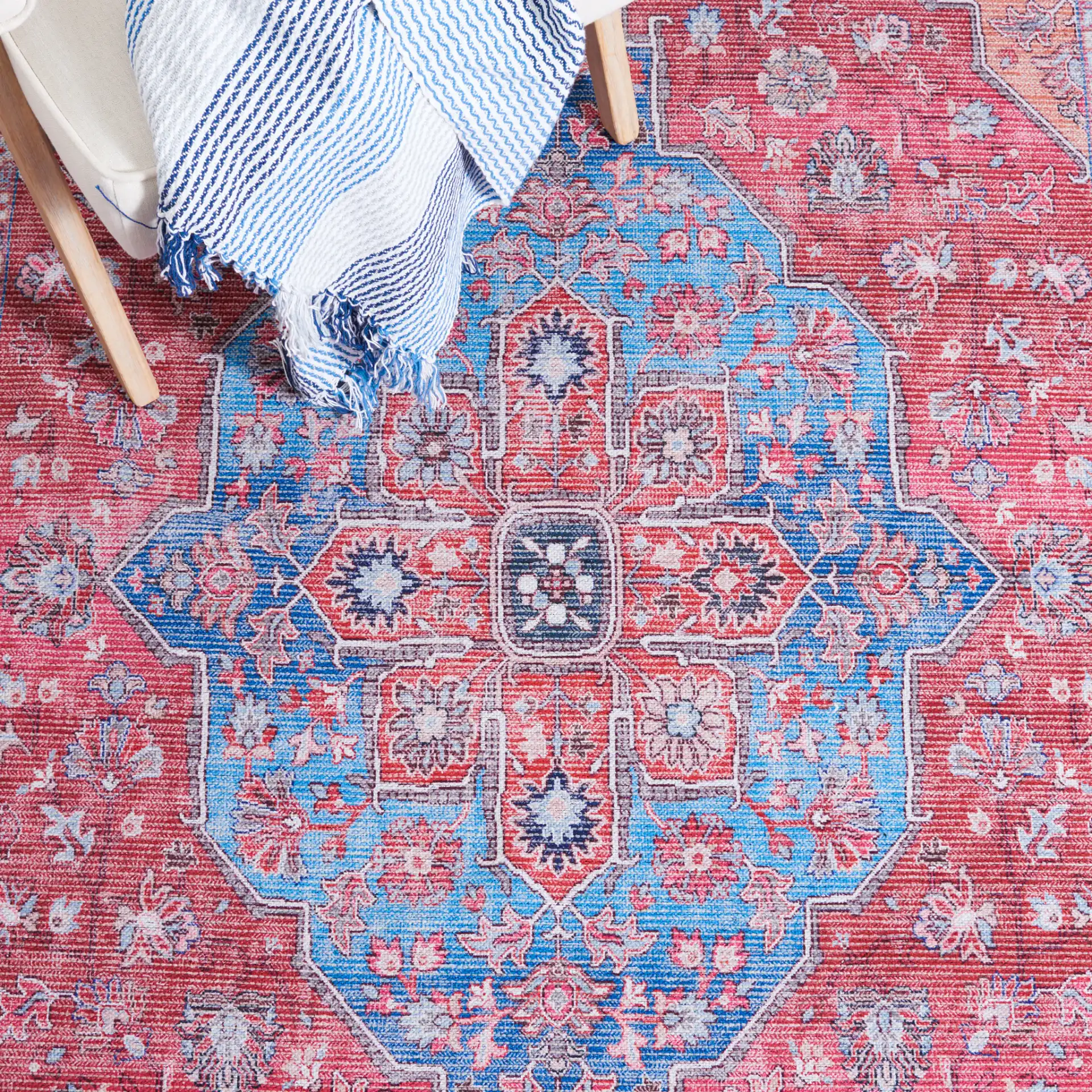 Serapi Star Medallion Washable Rug in Blue / Rust in a styled room