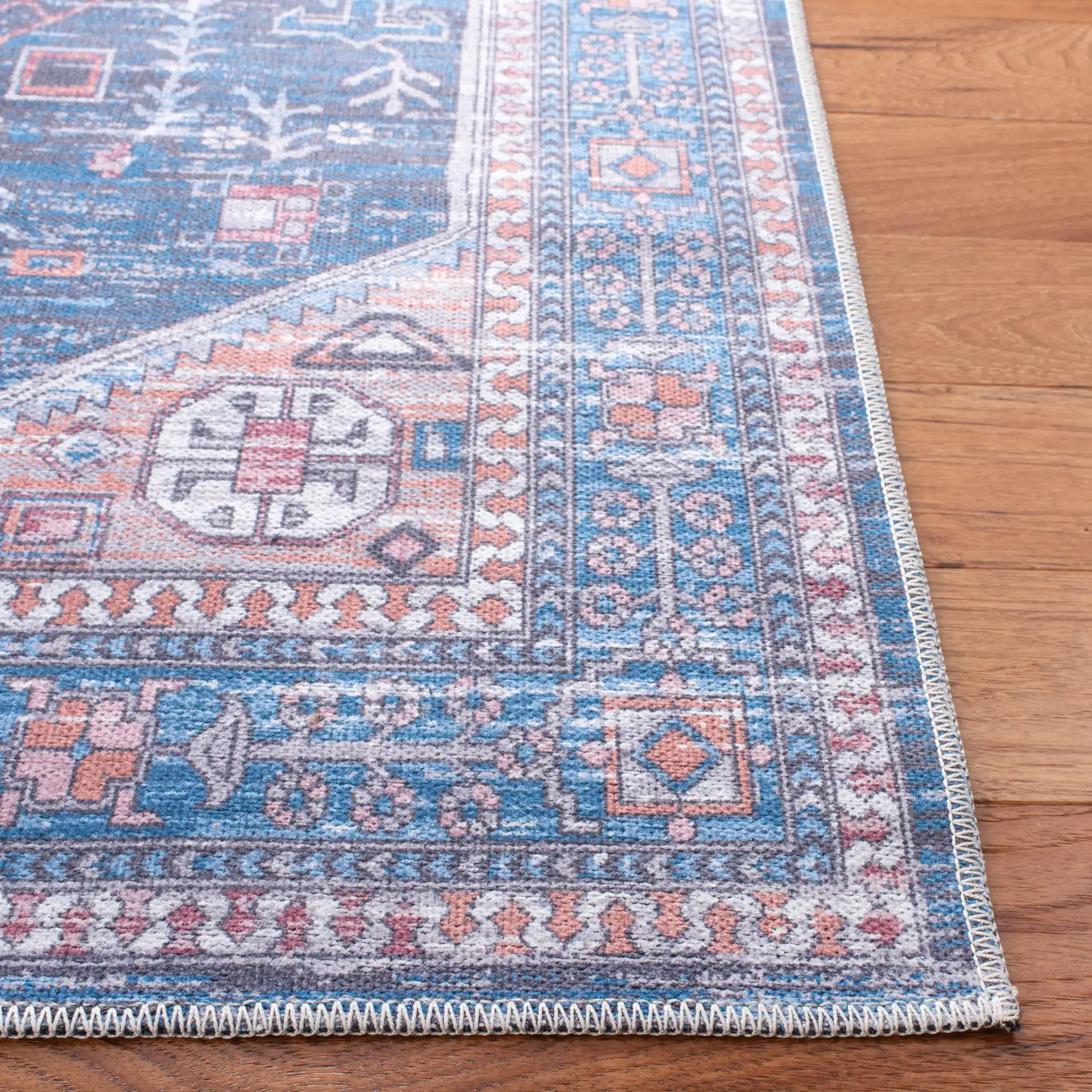 Serapi Diamond Medallion Washable Rug in Blue / Ivory in a styled room