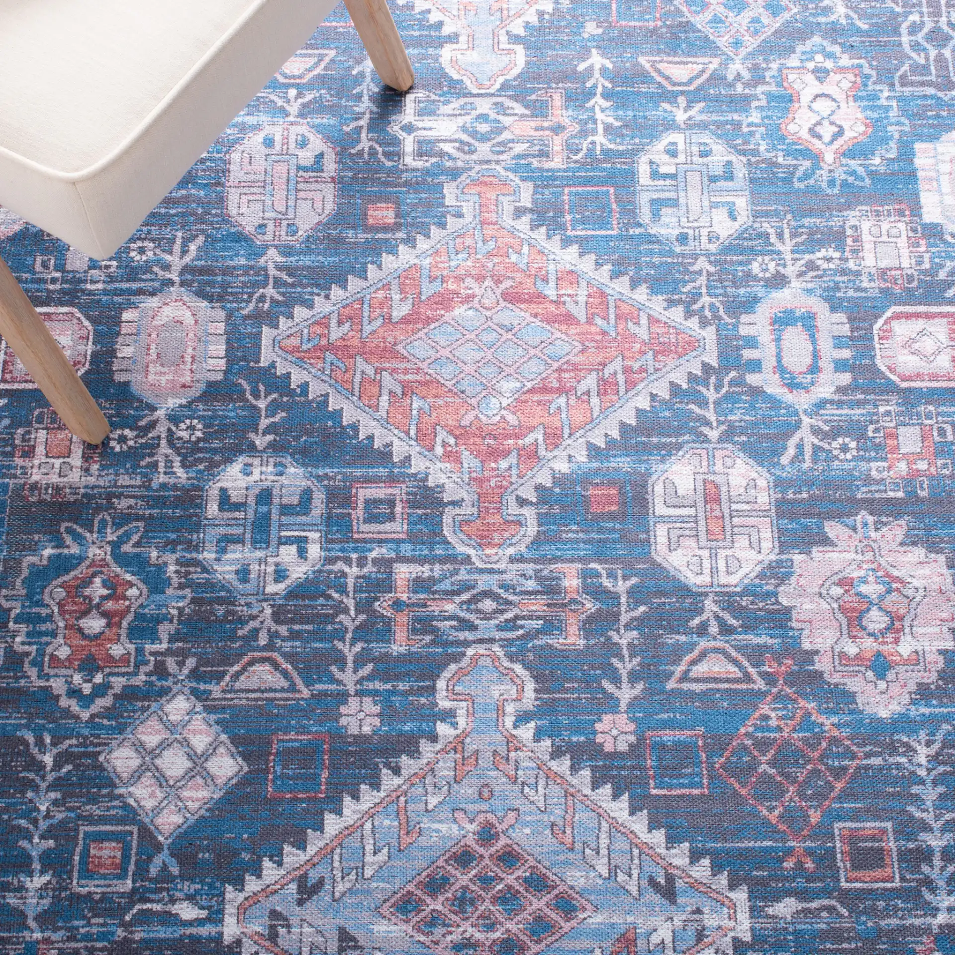 Serapi Diamond Medallion Washable Rug in Blue / Ivory in a styled room