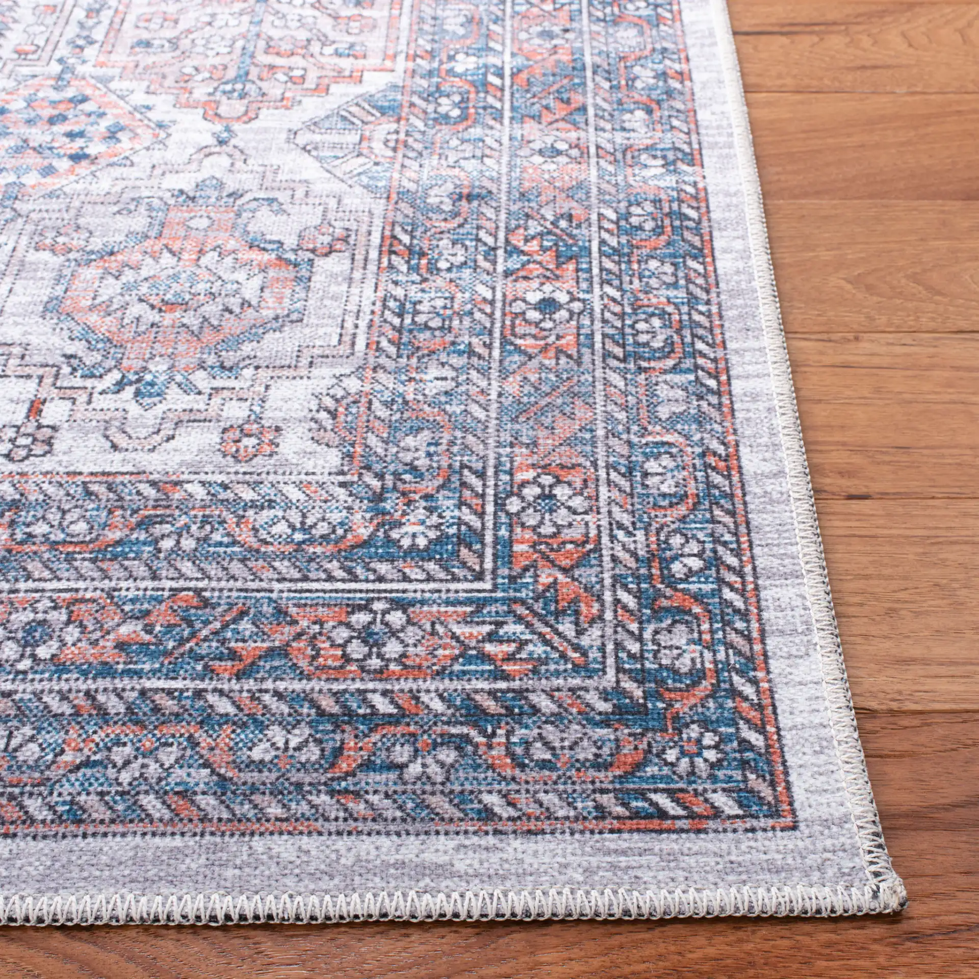 Serapi Geometric Grid Washable Rug in Ivory / Rust in a styled room