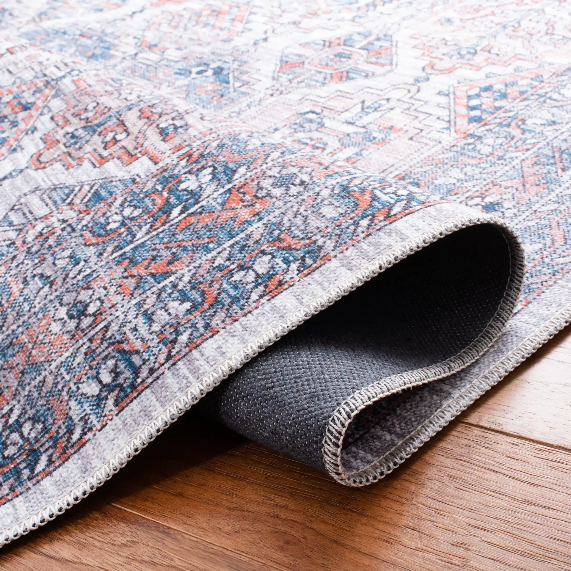 Serapi Geometric Grid Washable Rug in Ivory / Rust in a styled room