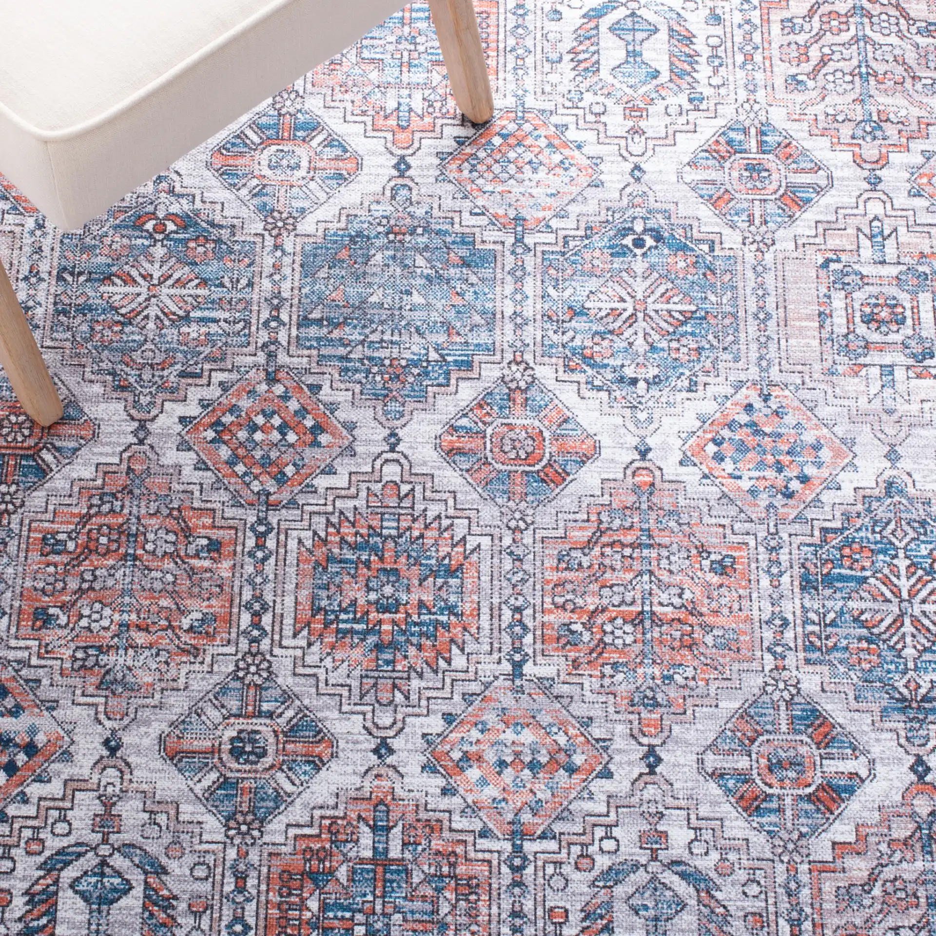 Serapi Geometric Grid Washable Rug in Ivory / Rust in a styled room