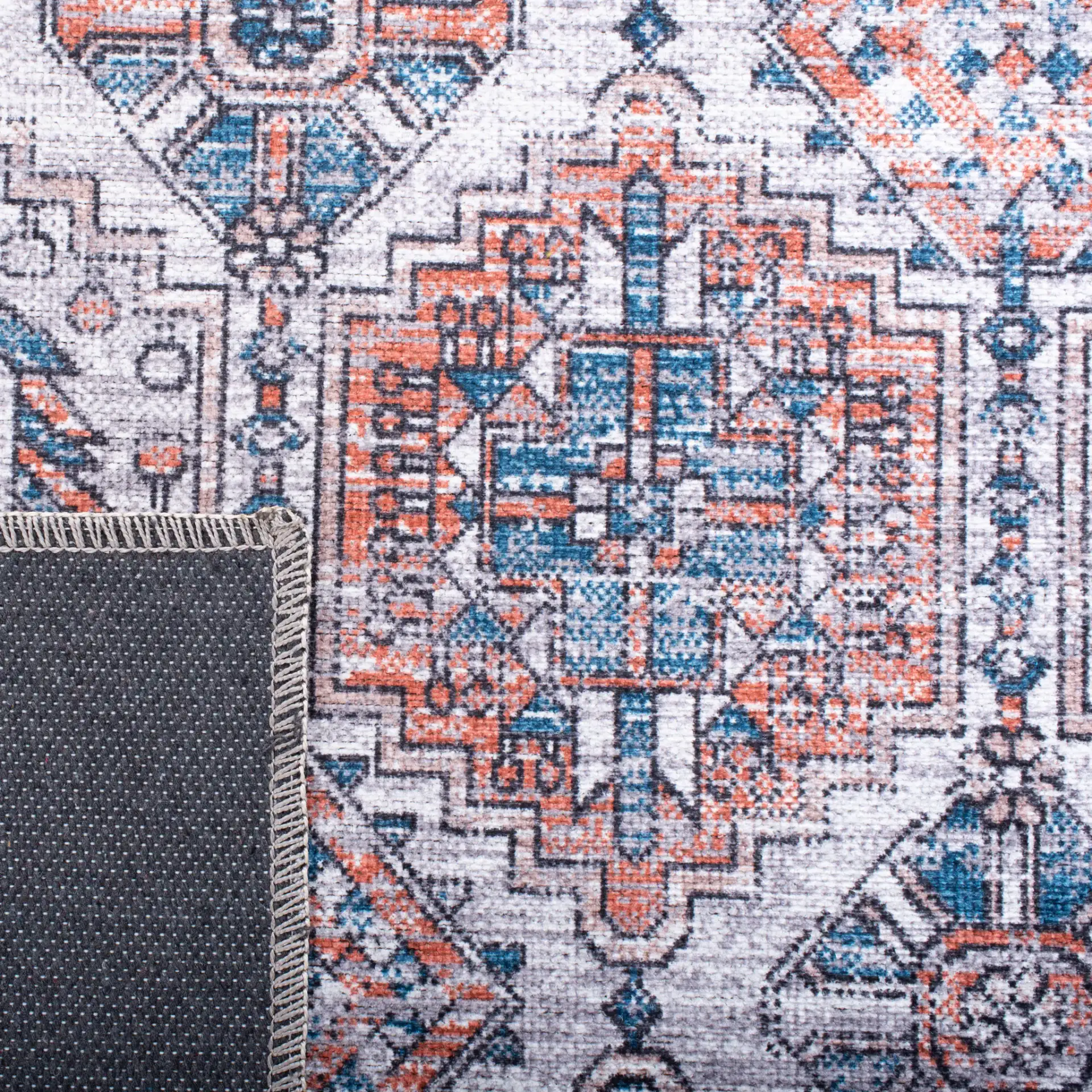 Serapi Geometric Grid Washable Rug in Ivory / Rust in a styled room