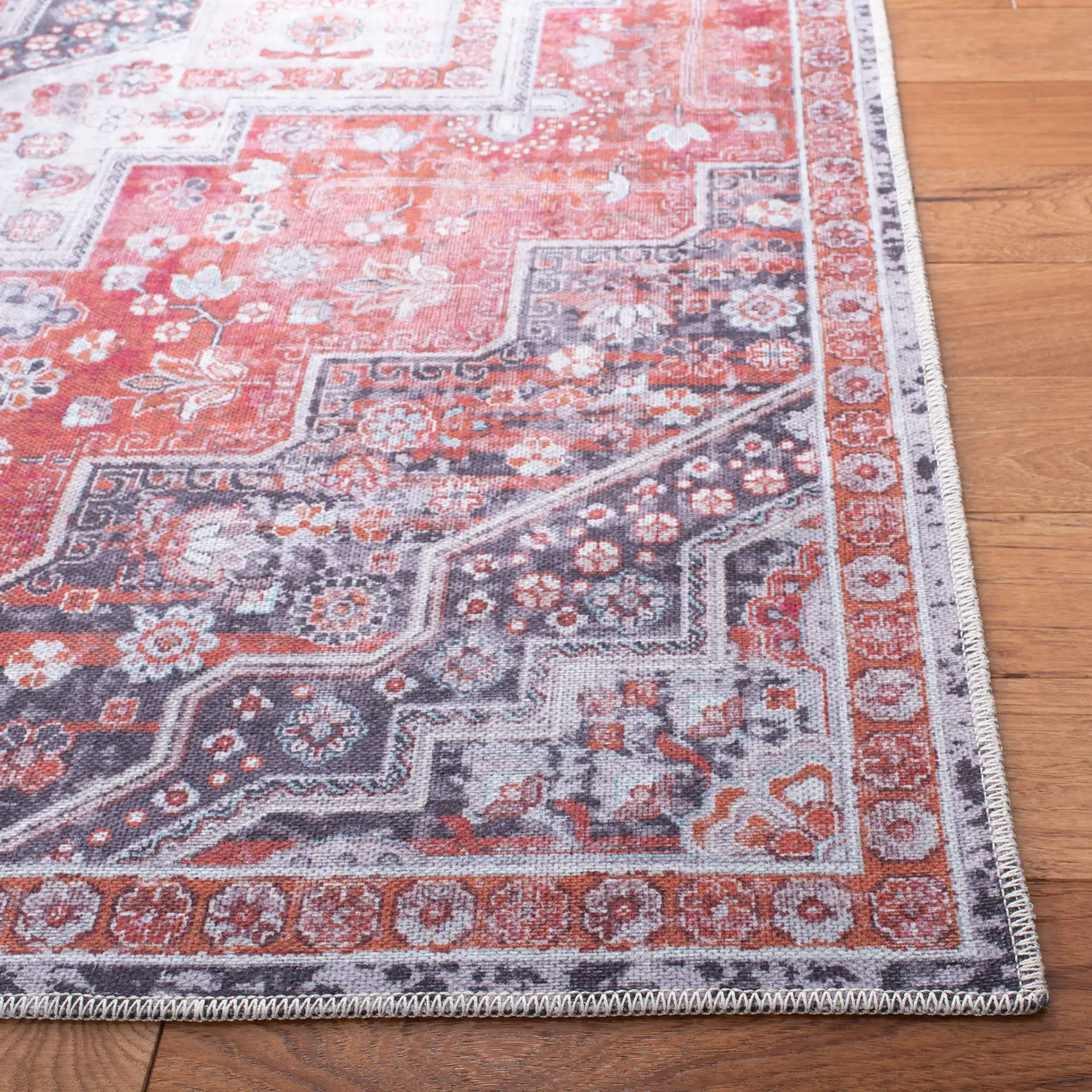 Serapi Nested Medallion Washable Rug in Rust / Ivory in a styled room