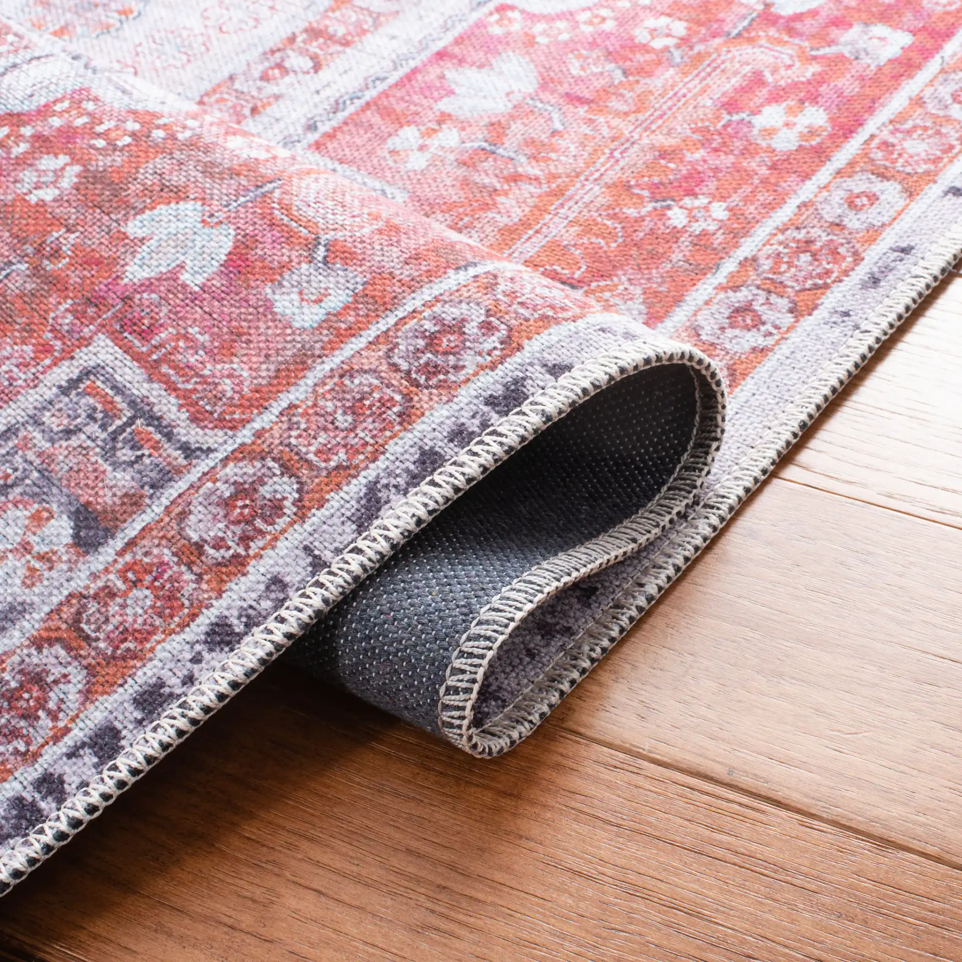 Serapi Nested Medallion Washable Rug in Rust / Ivory in a styled room