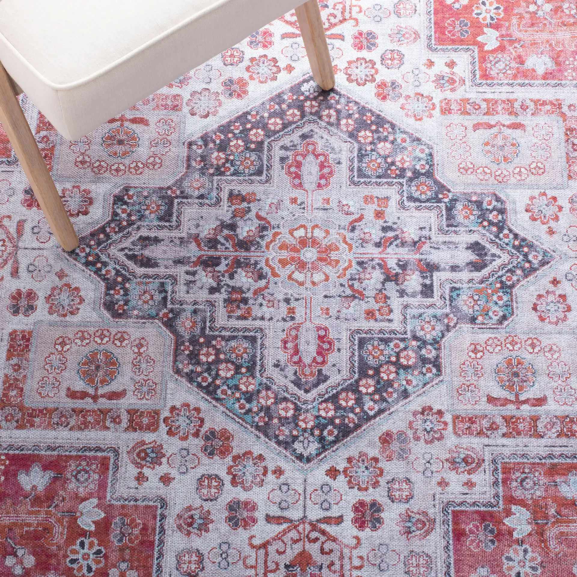 Serapi Nested Medallion Washable Rug in Rust / Ivory in a styled room