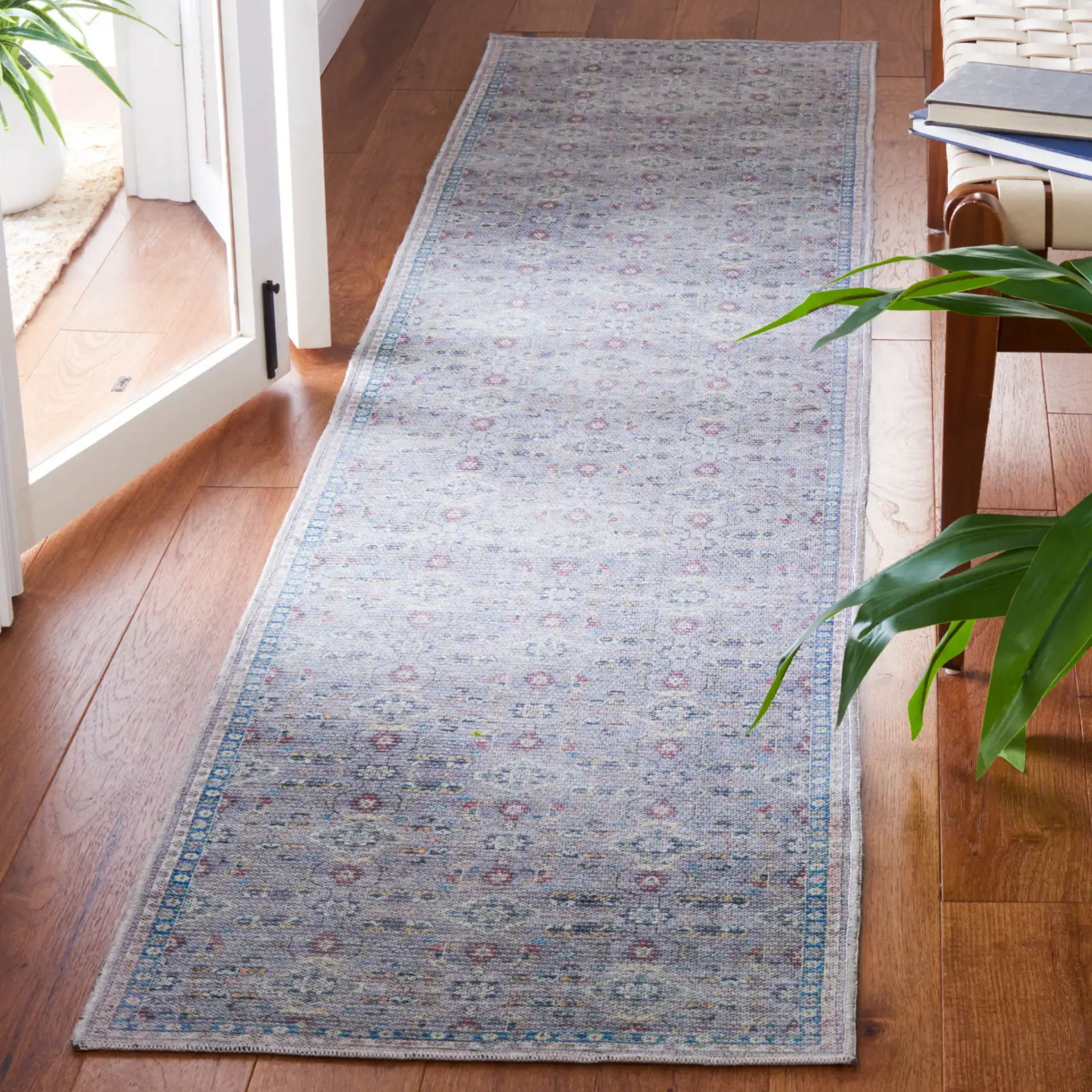 Serapi Floral Border Washable Rug in Gray / Beige in a styled room