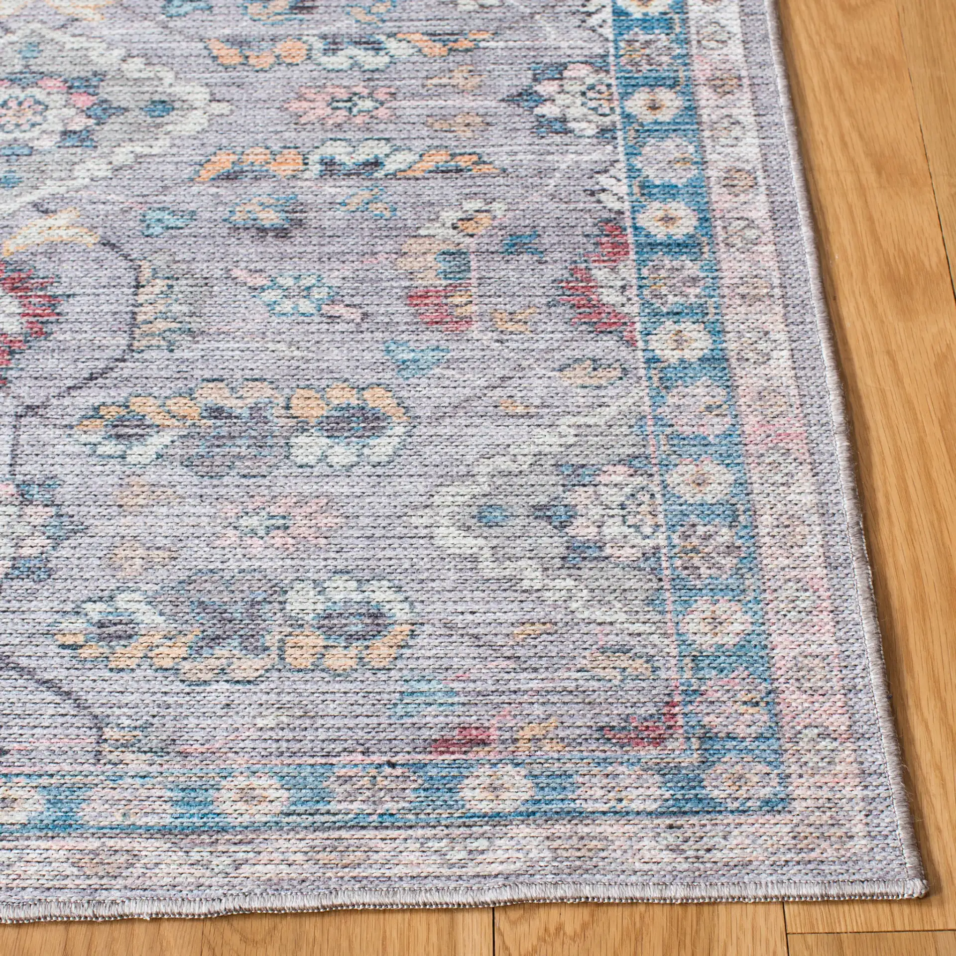 Serapi Floral Border Washable Rug in Gray / Beige in a styled room