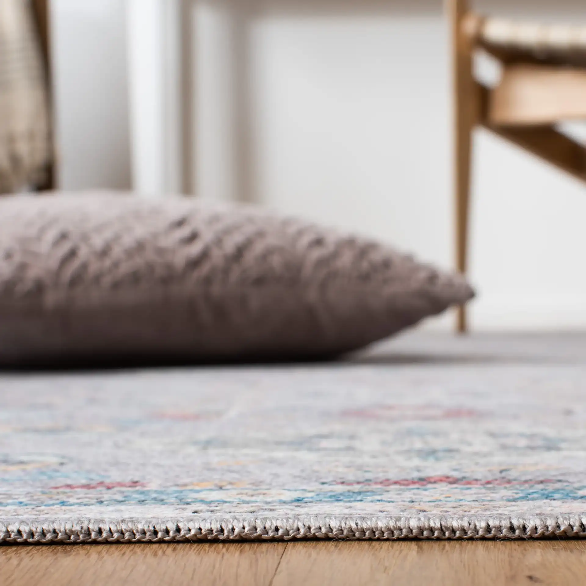 Serapi Floral Border Washable Rug in Gray / Beige in a styled room