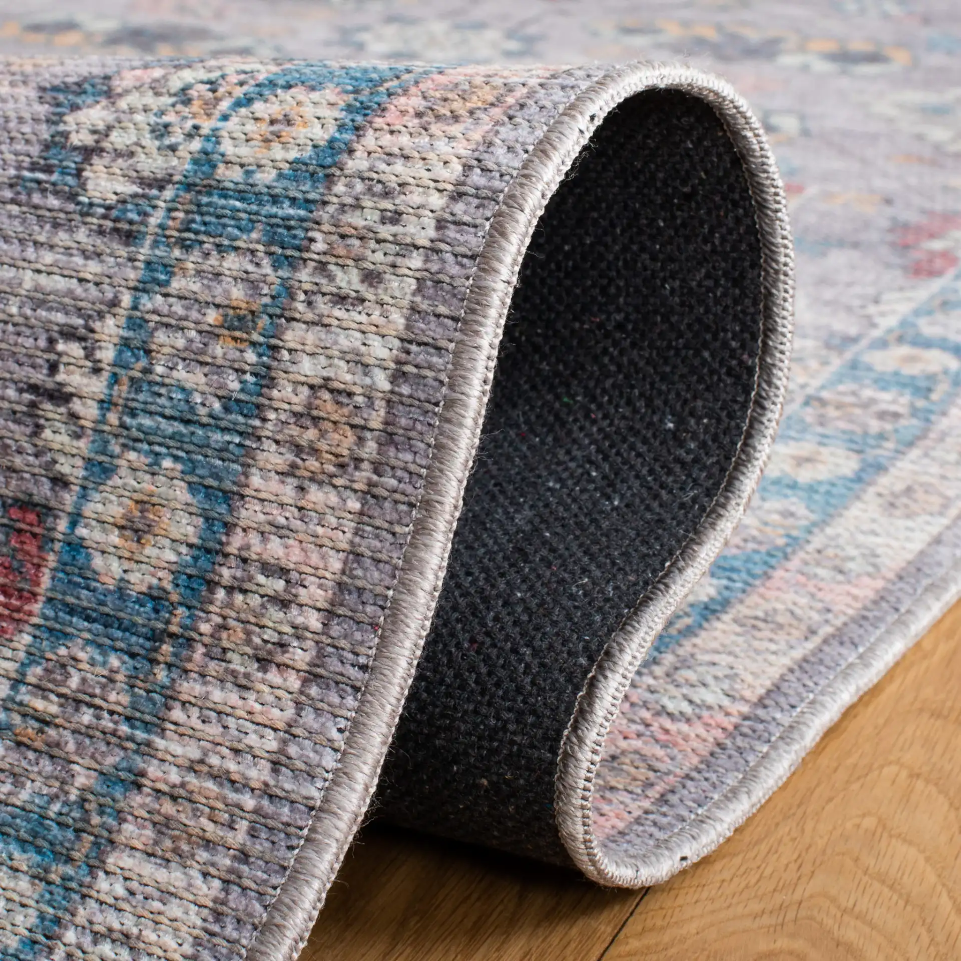 Serapi Floral Border Washable Rug in Gray / Beige in a styled room