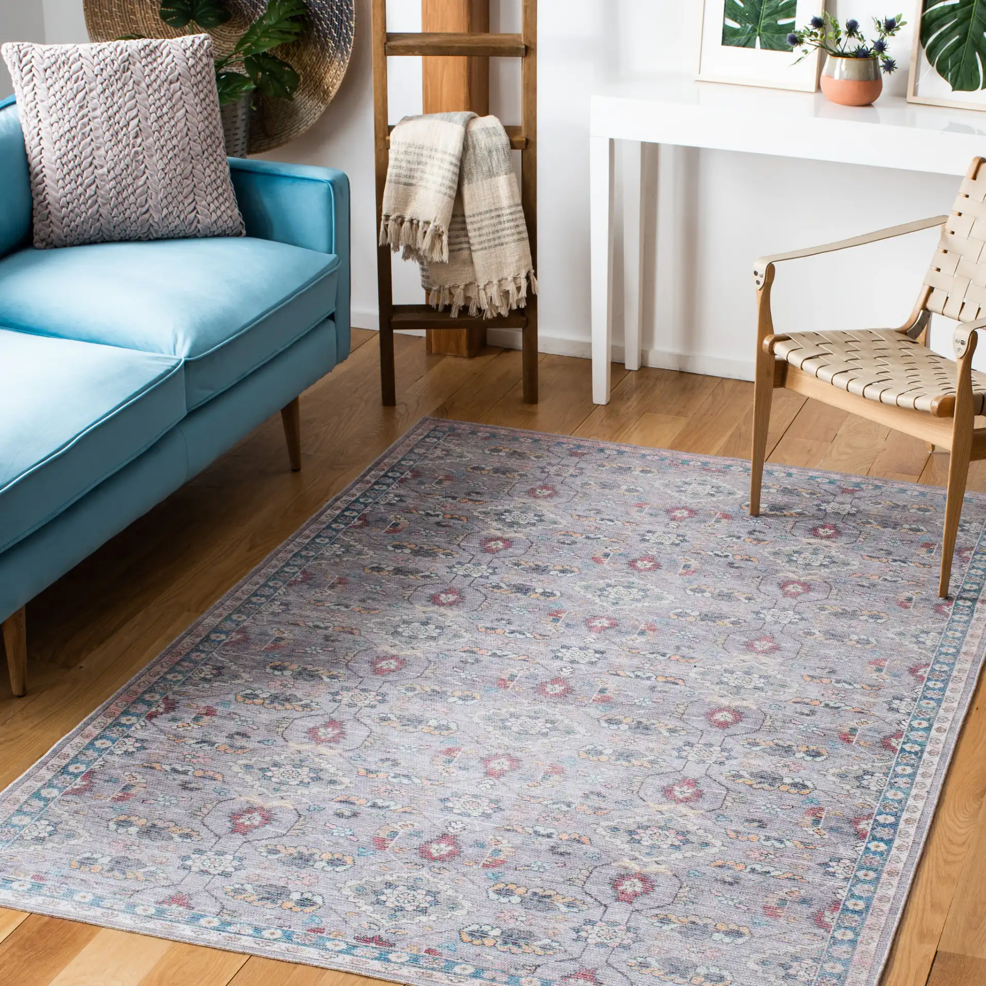 Serapi Floral Border Washable Rug in Gray / Beige in a styled room