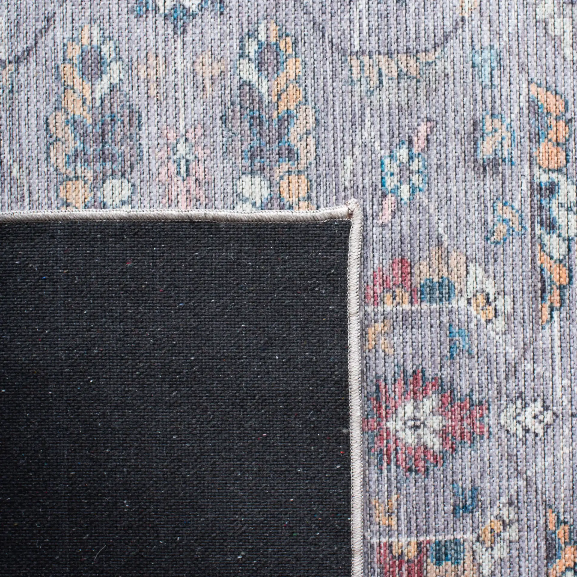 Serapi Floral Border Washable Rug in Gray / Beige in a styled room