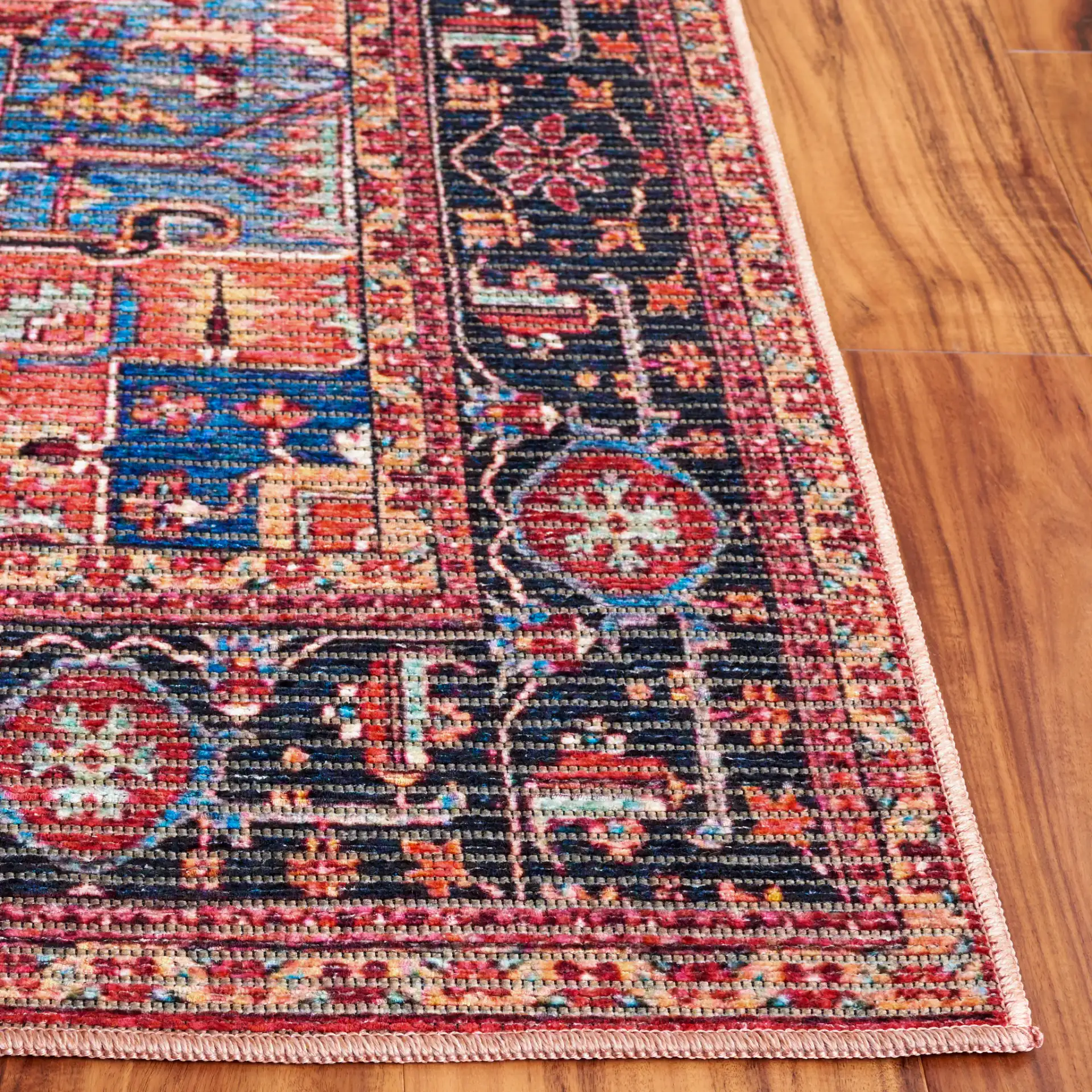 Serapi Bordered Medallion Washable Rug in Red / Blue in a styled room