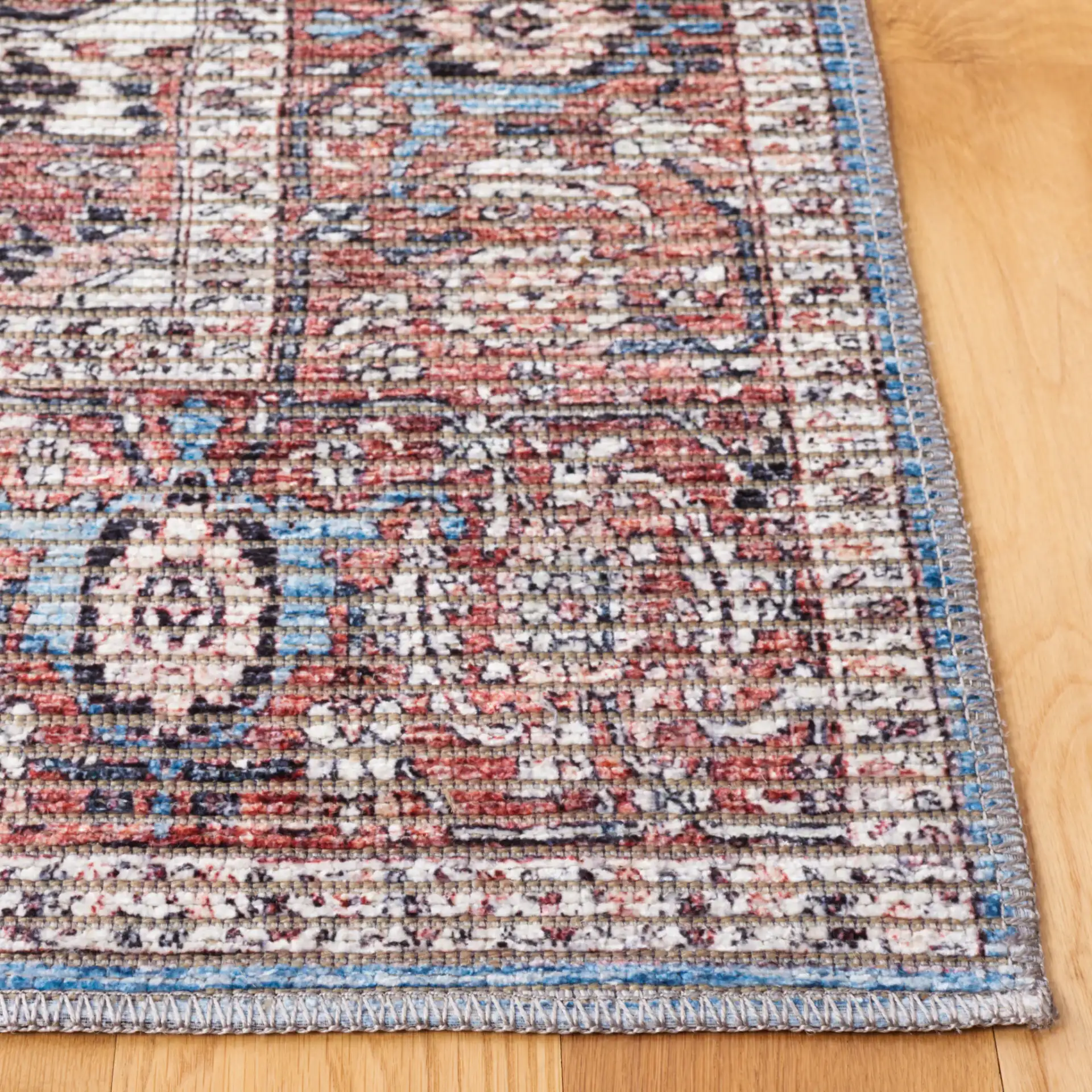 Serapi Framed Medallion Washable Rug in Blue / Rust in a styled room