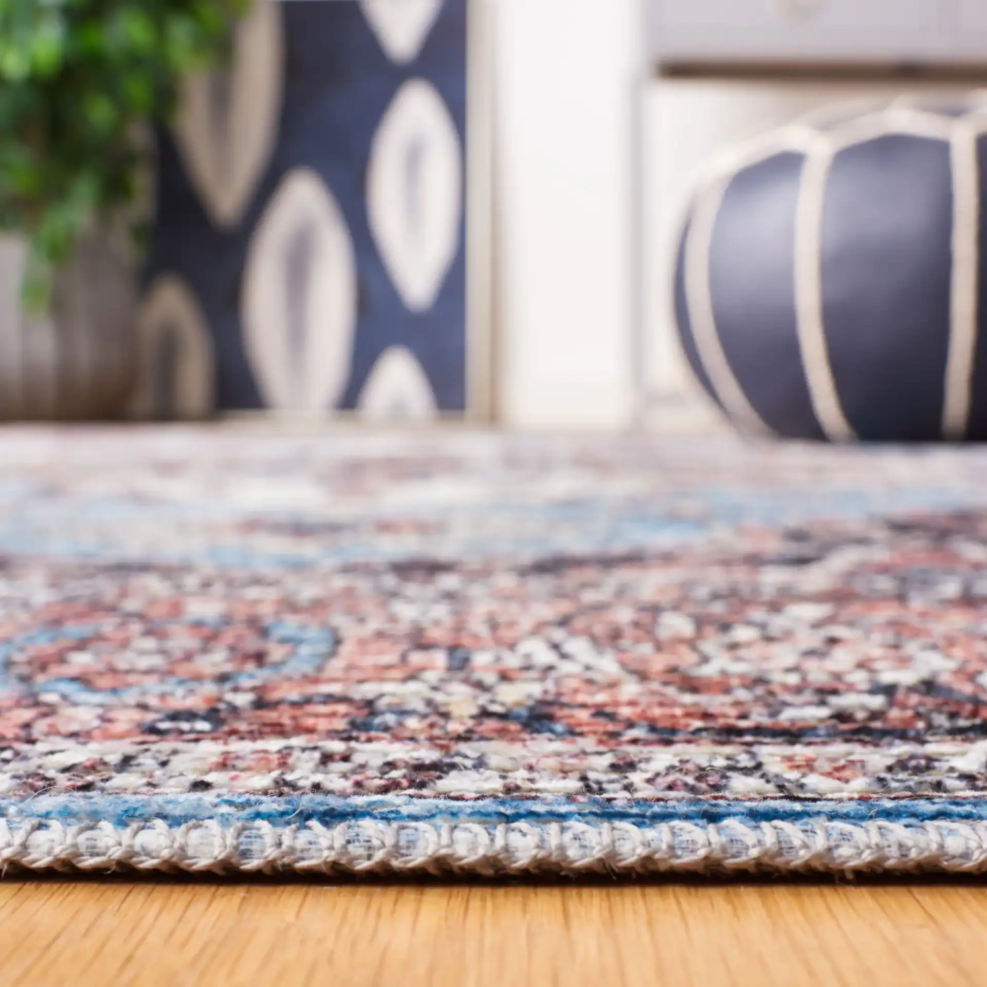 Serapi Framed Medallion Washable Rug in Blue / Rust in a styled room
