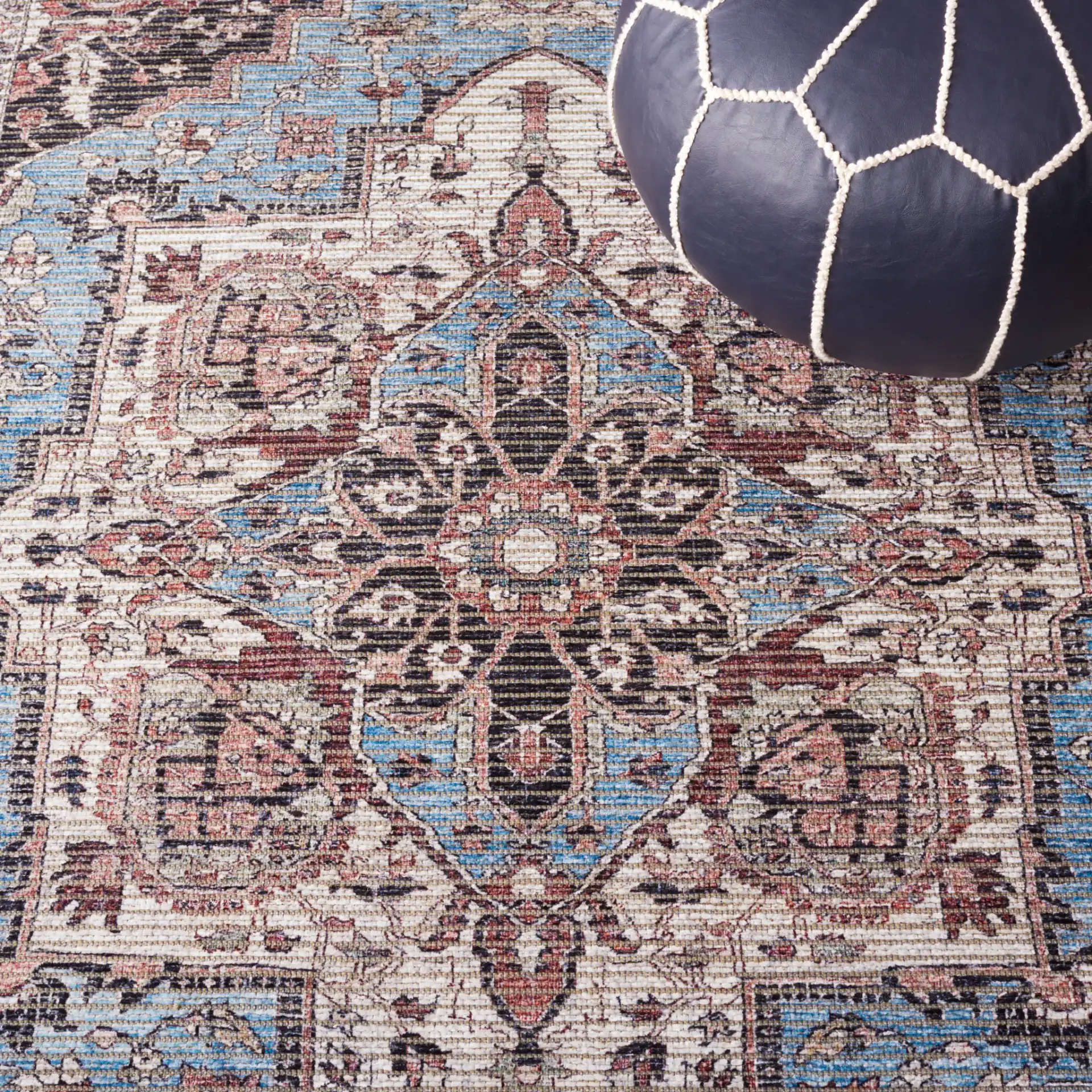 Serapi Framed Medallion Washable Rug in Blue / Rust in a styled room