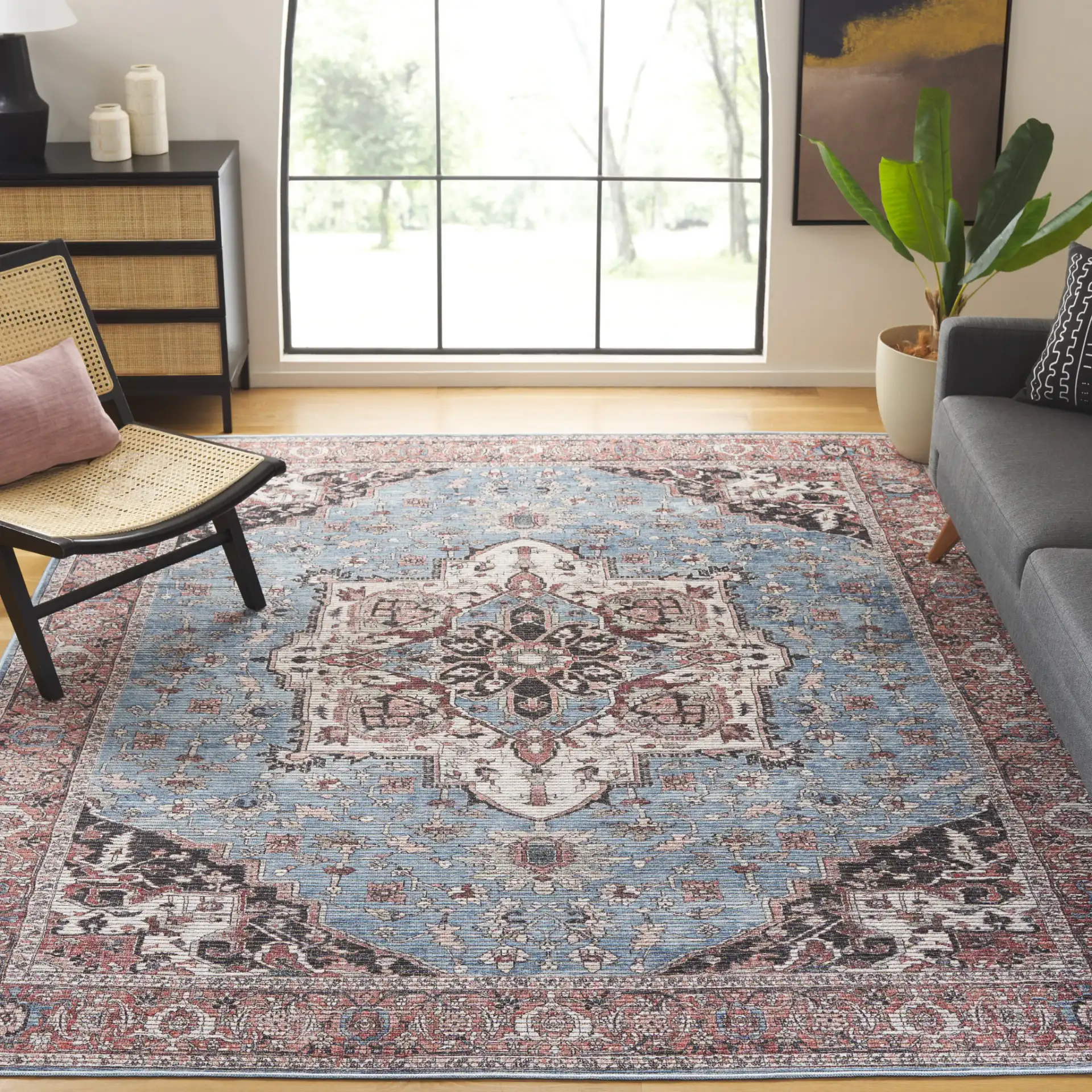 Serapi Framed Medallion Washable Rug in Blue / Rust in a styled room