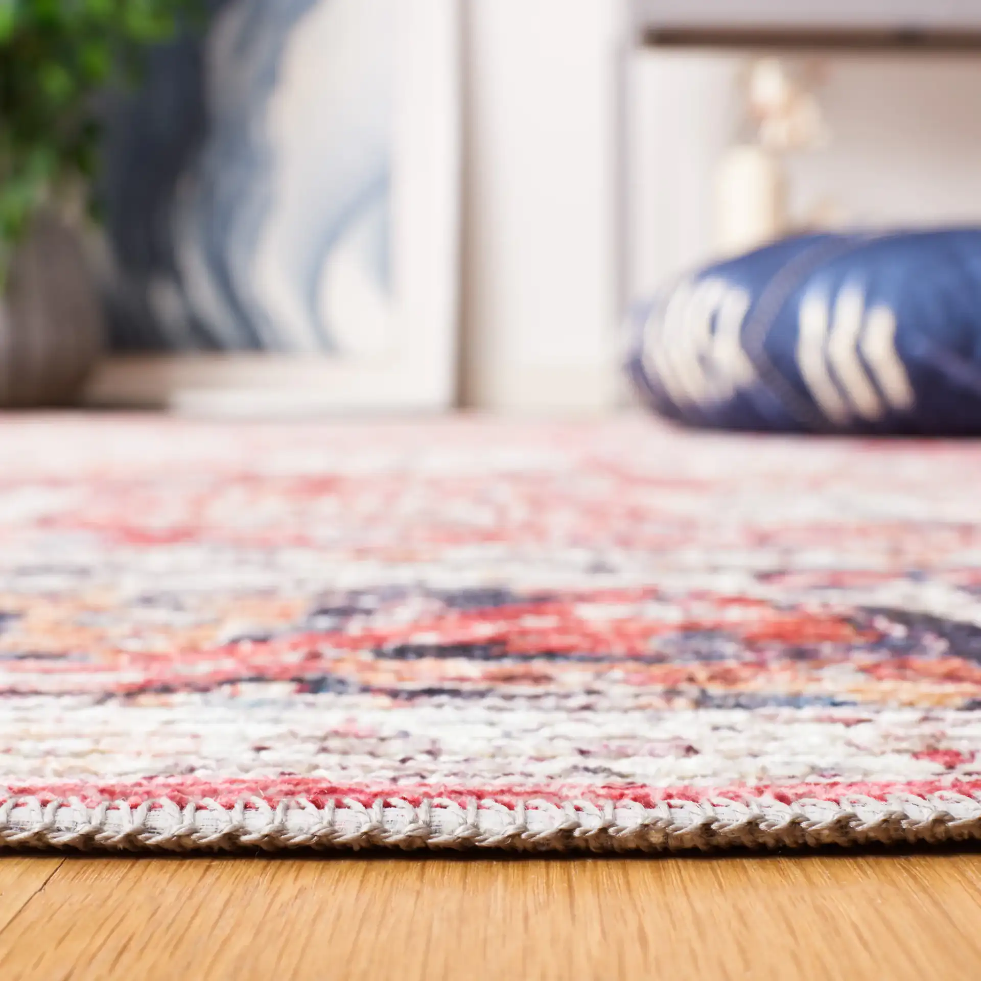 Serapi Distressed Floral Washable Rug in Rust / Gray in a styled room