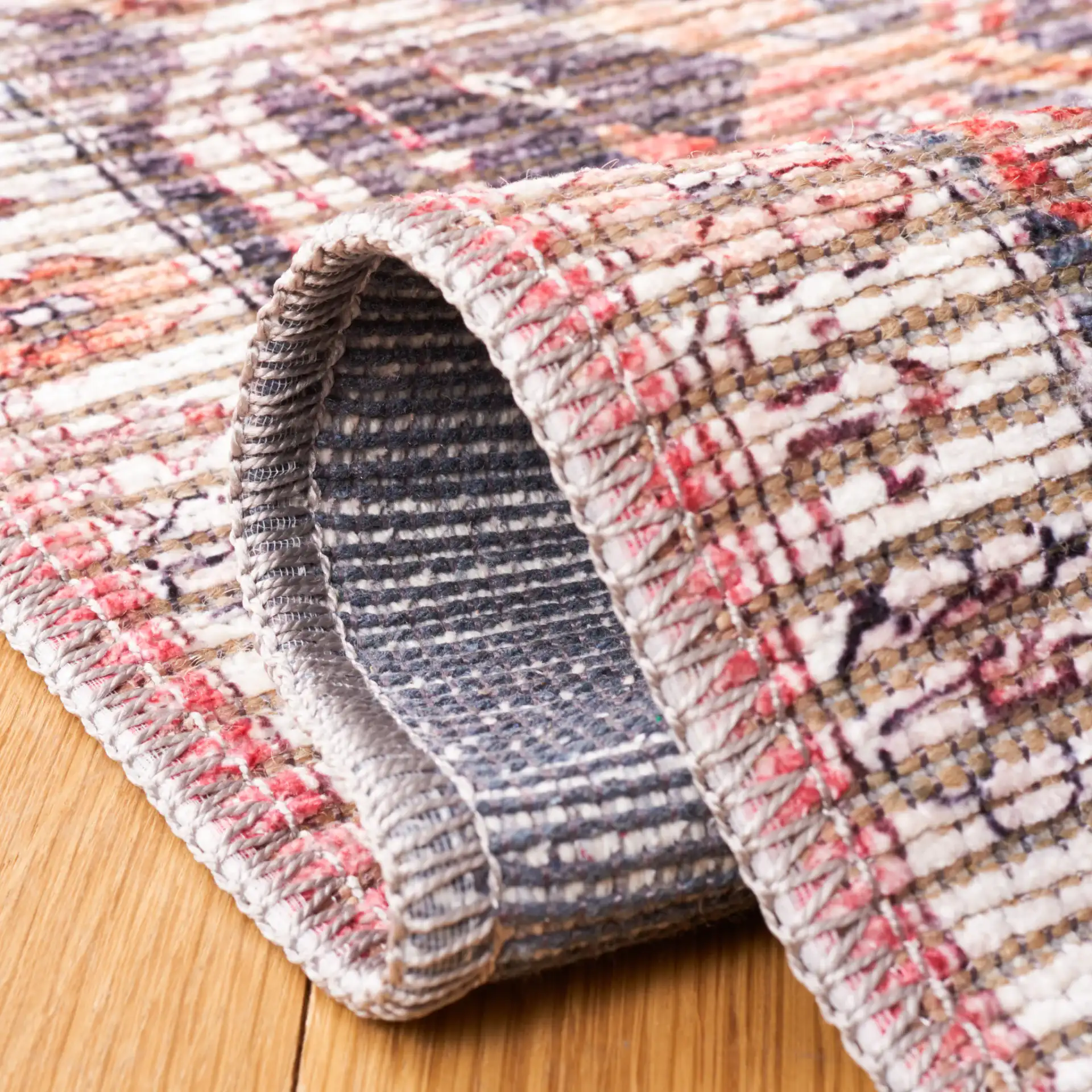 Serapi Distressed Floral Washable Rug in Rust / Gray in a styled room