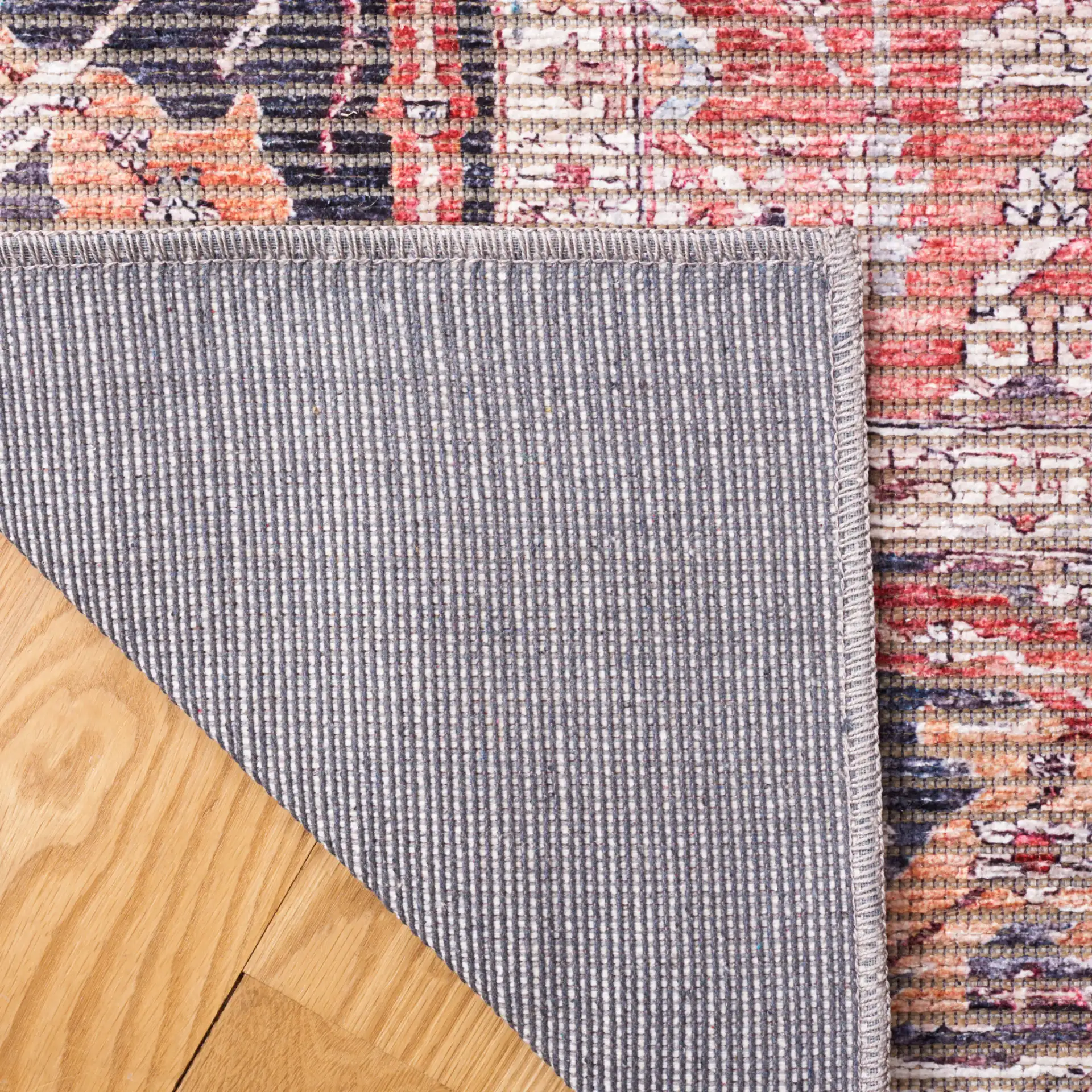 Serapi Distressed Floral Washable Rug in Rust / Gray in a styled room