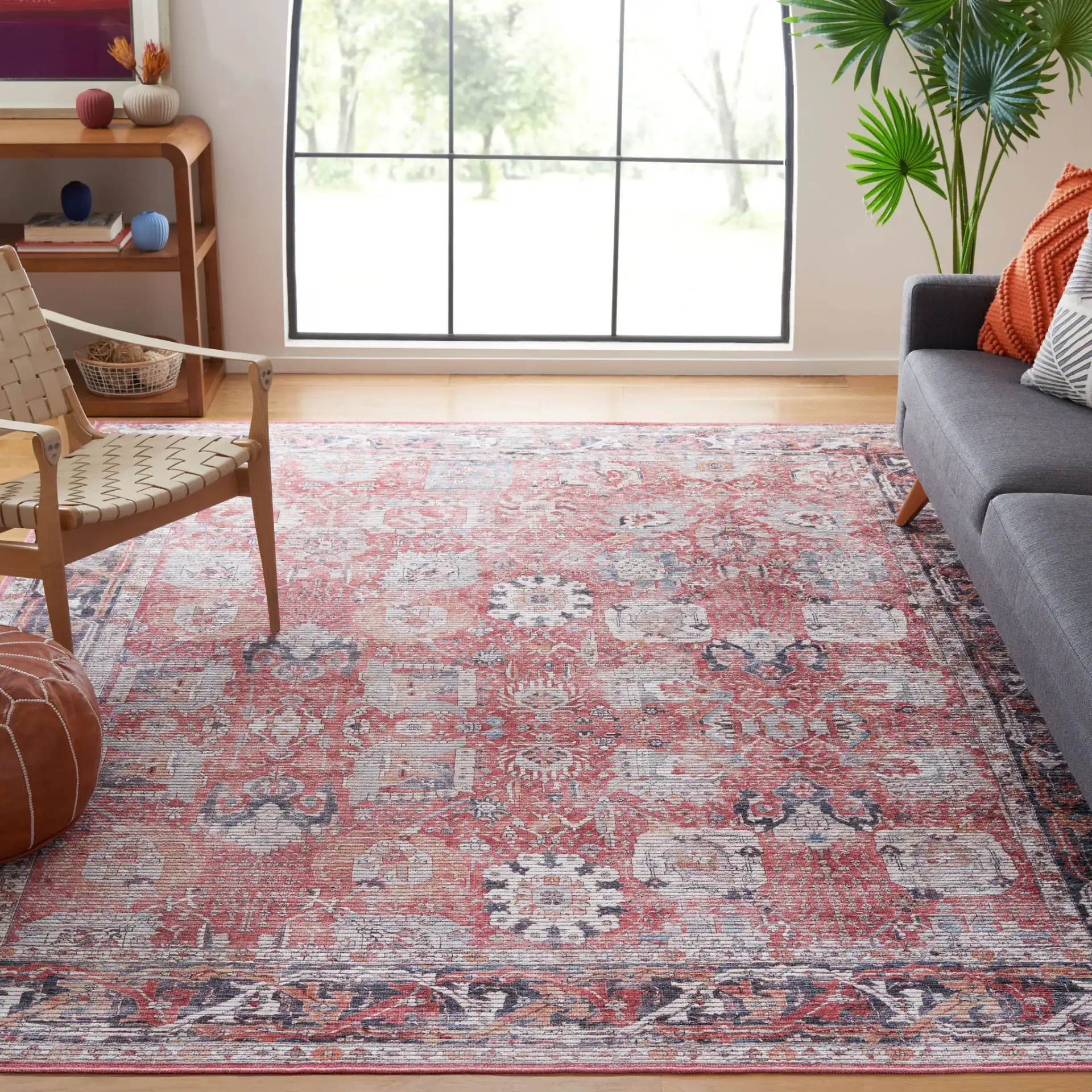 Serapi Distressed Floral Washable Rug in Rust / Gray in a styled room
