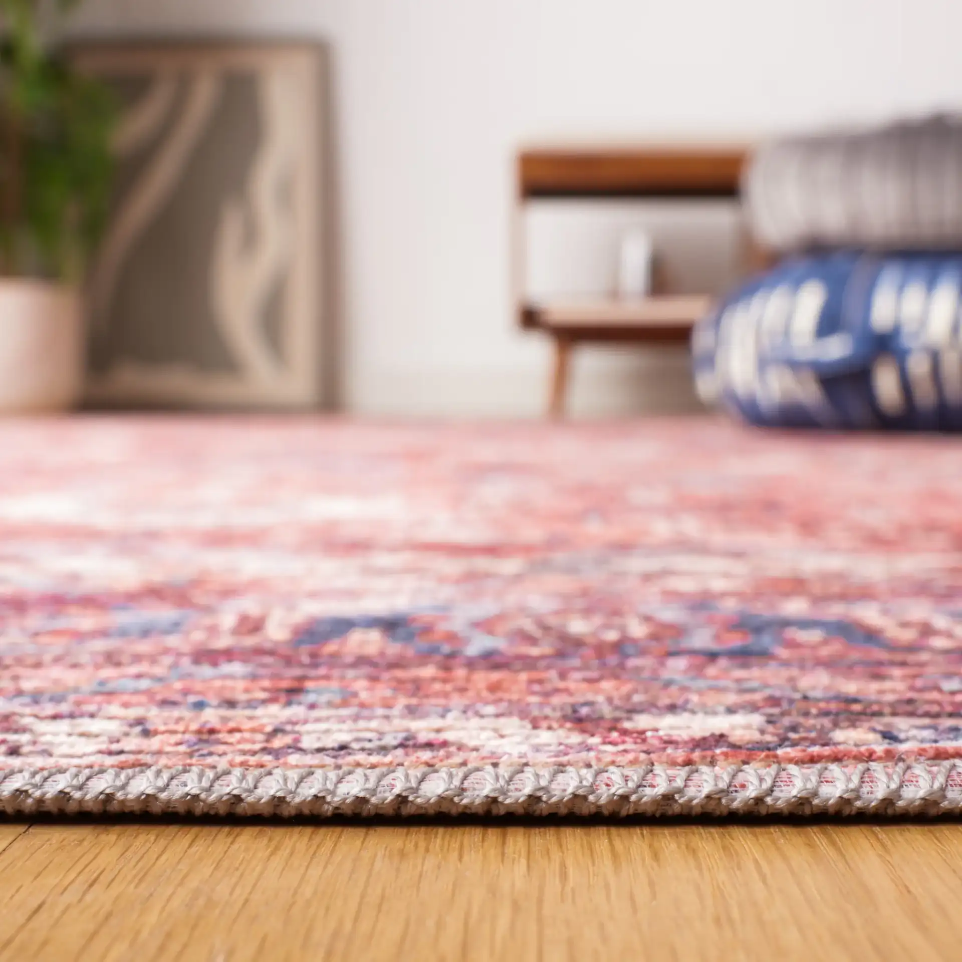 Serapi Distressed Geometric Washable Rug in Rust / Blue in a styled room
