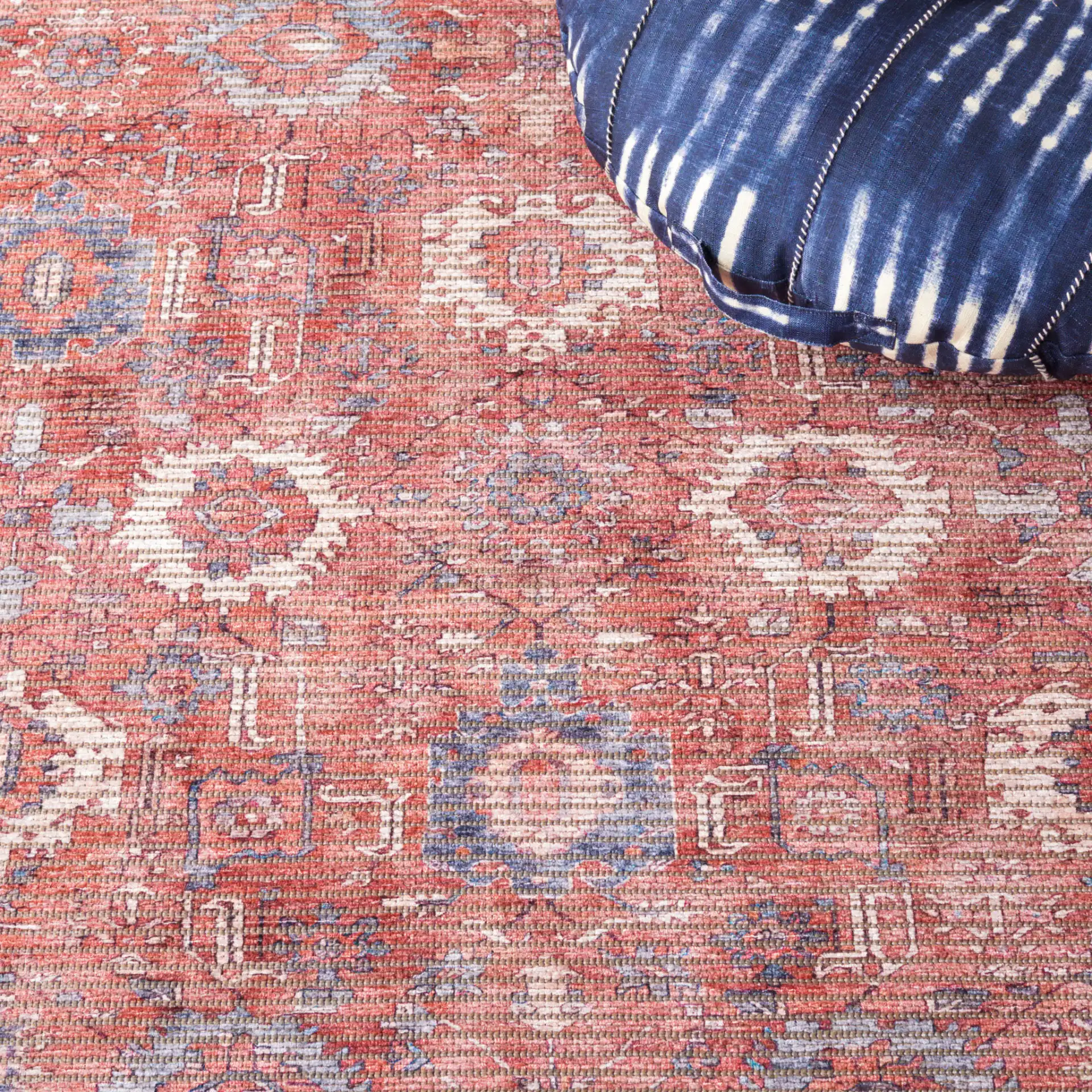 Serapi Distressed Geometric Washable Rug in Rust / Blue in a styled room