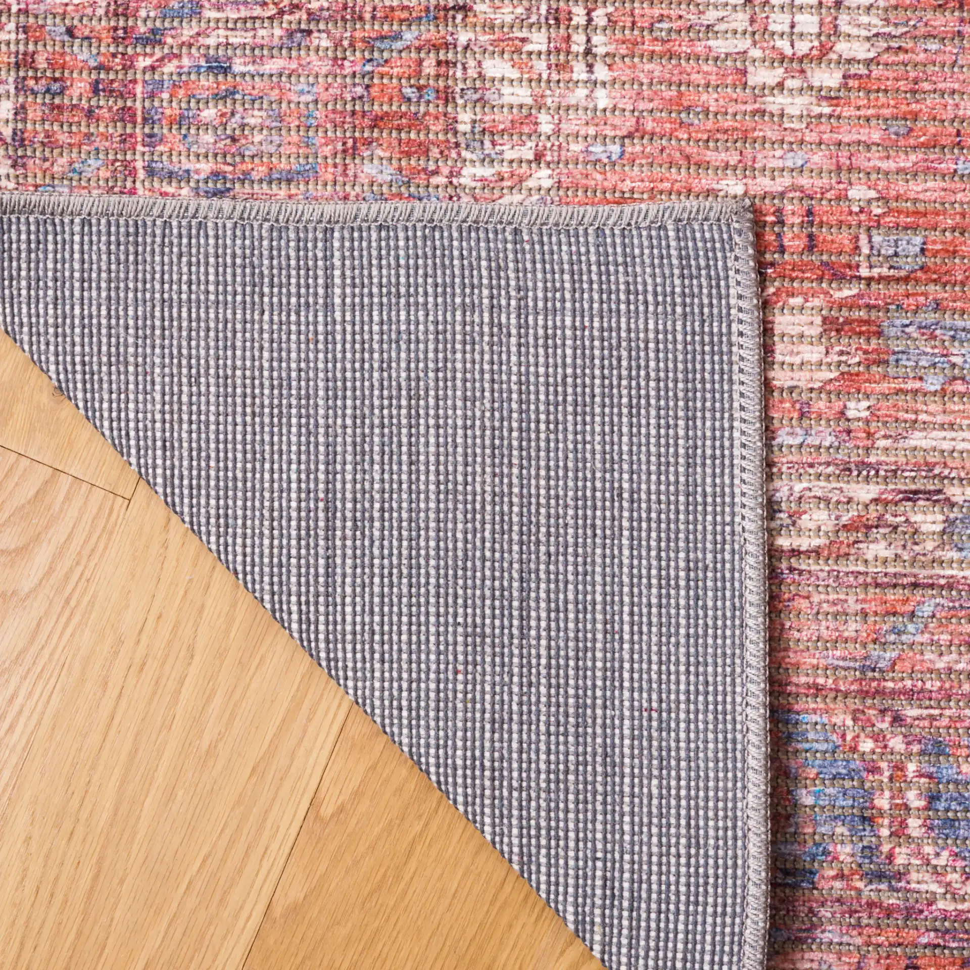 Serapi Distressed Geometric Washable Rug in Rust / Blue in a styled room