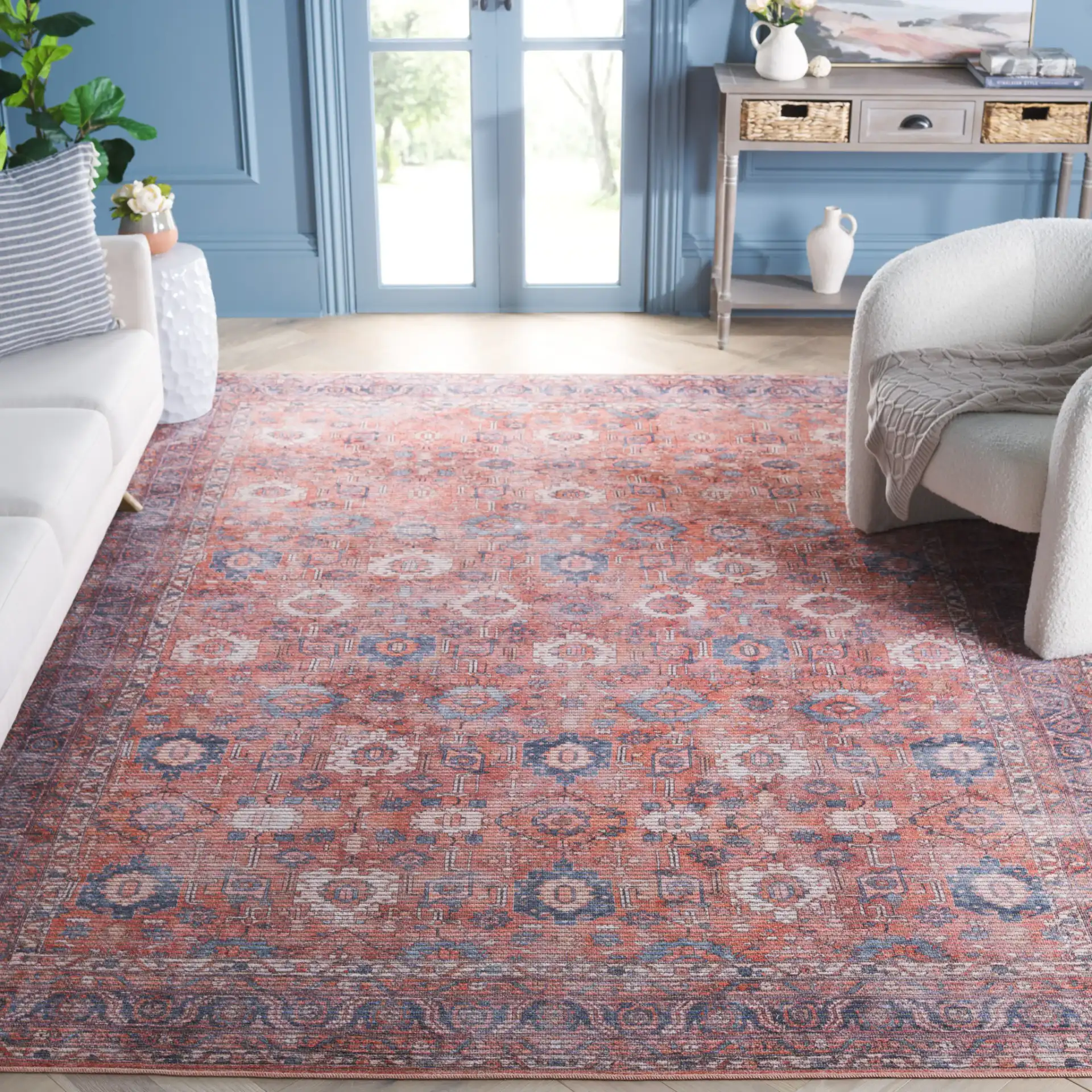 Serapi Distressed Geometric Washable Rug in Rust / Blue in a styled room