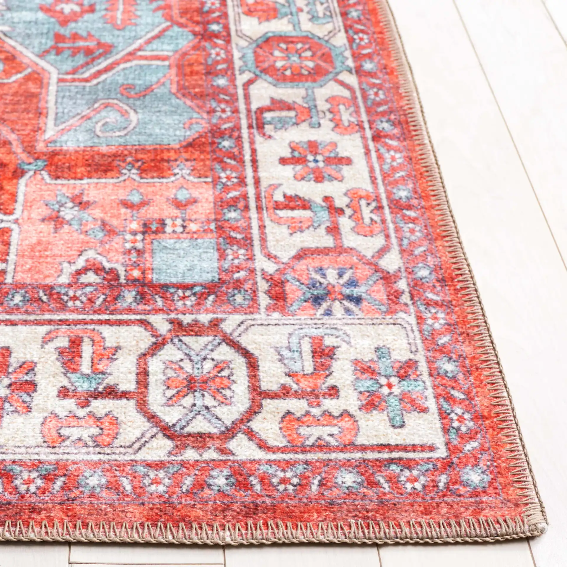 Serapi Geometric Medallion Washable Rug in Rust / Blue in a styled room