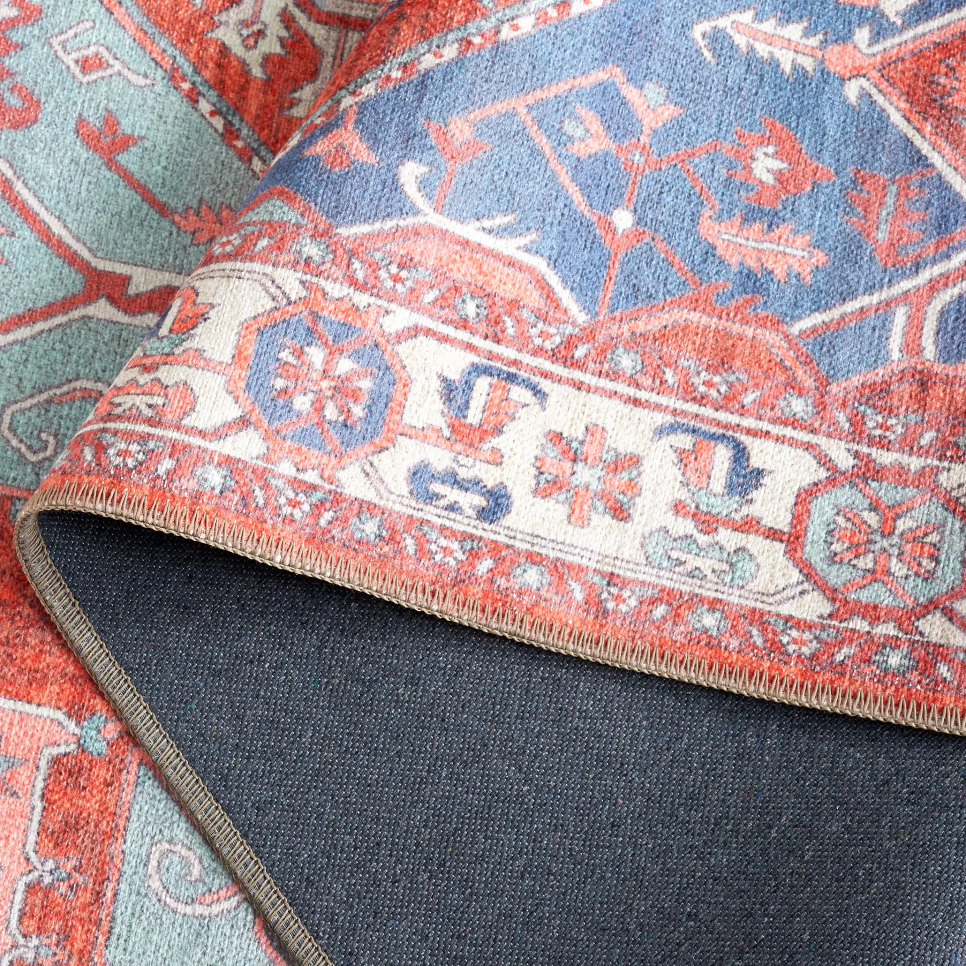 Serapi Geometric Medallion Washable Rug in Rust / Blue in a styled room